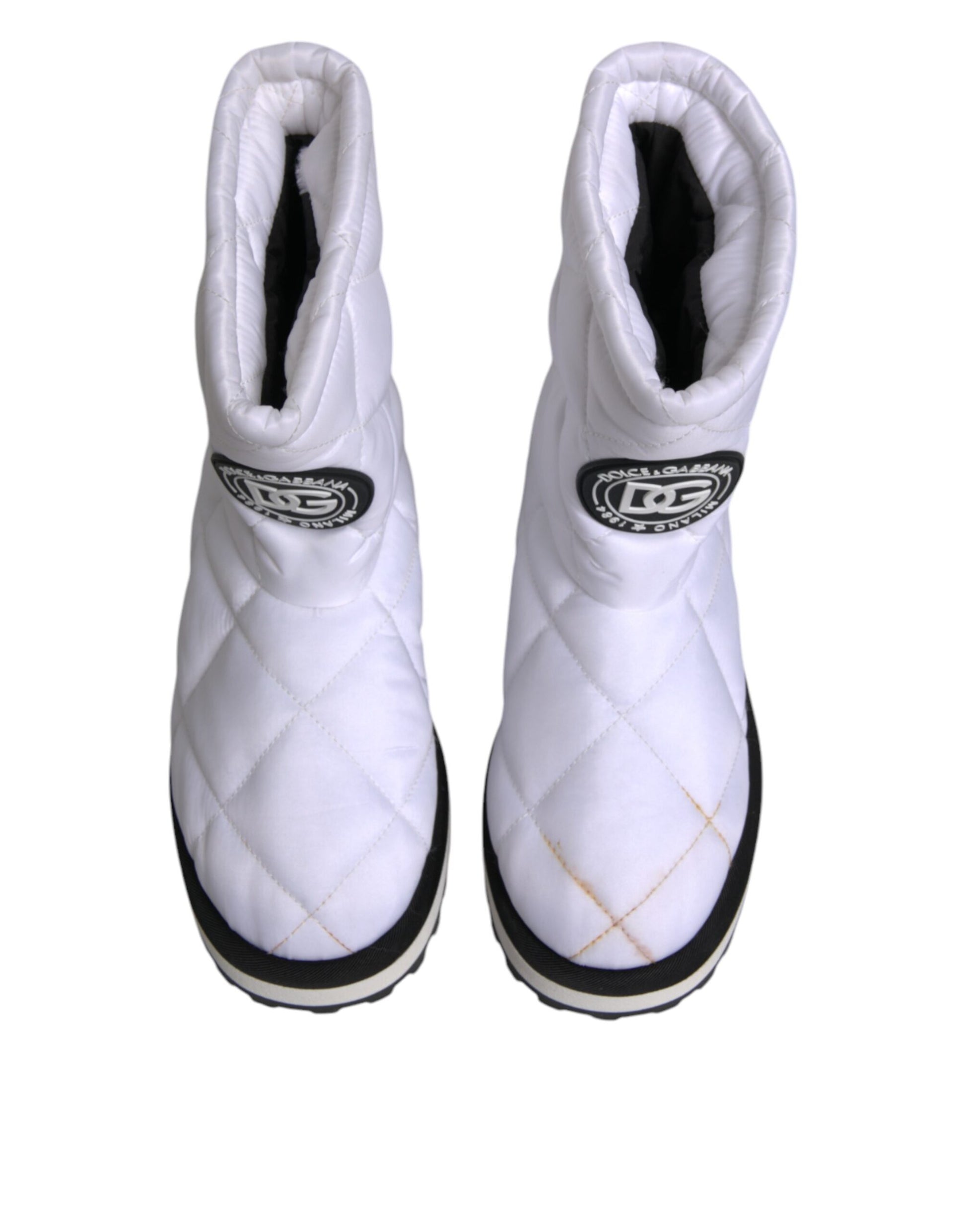 Pair of white snow boots with black laces
