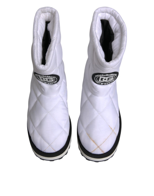 Pair of white snow boots with black laces