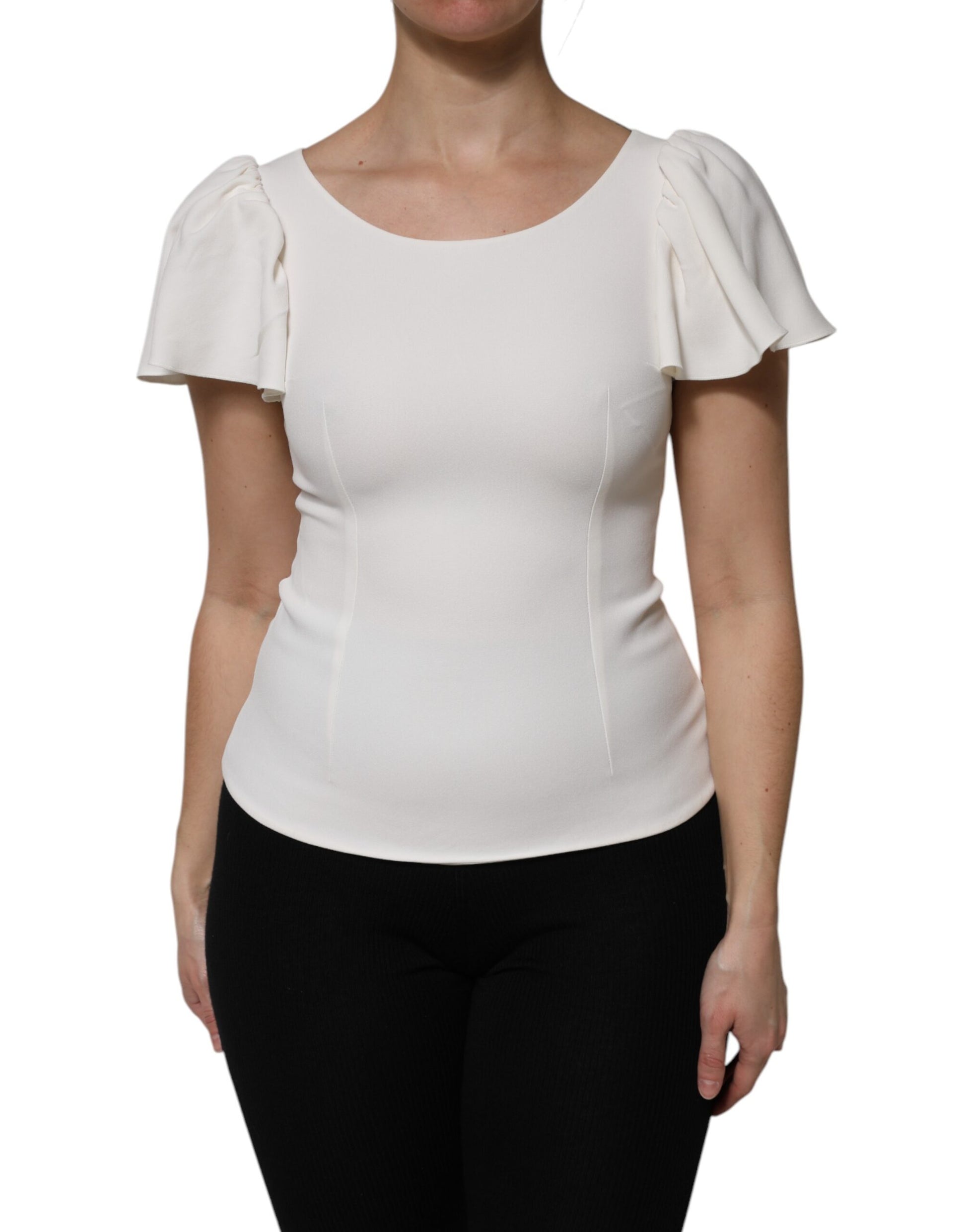 Woman wearing white blouse with ruffled sleeves