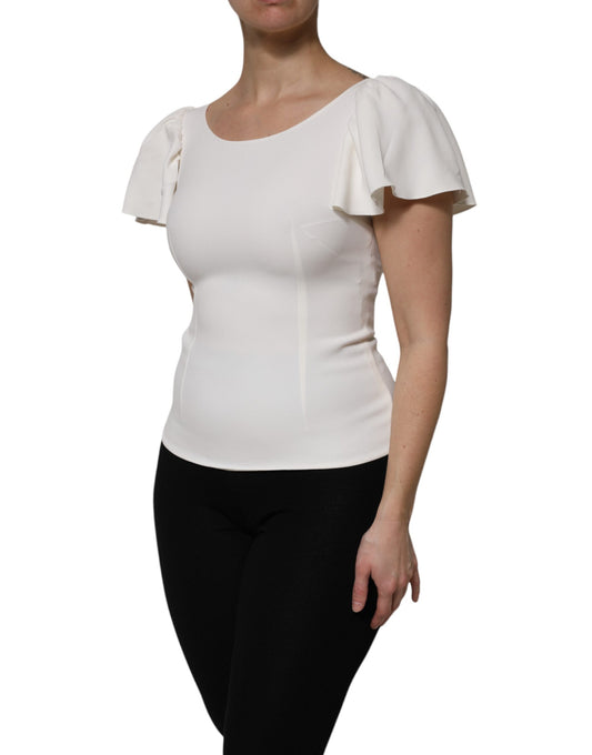 Woman wearing white top with ruffled sleeves