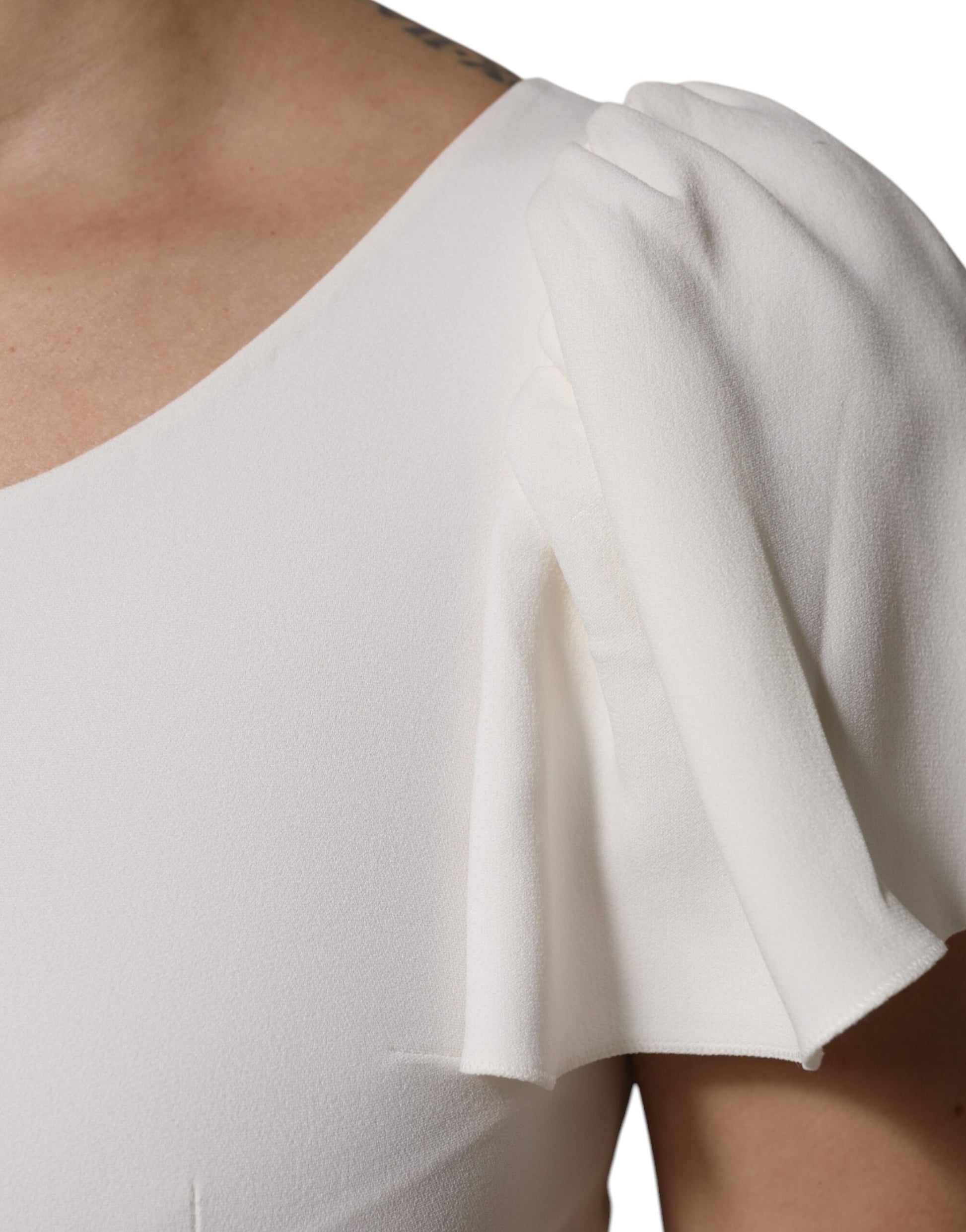 White sleeveless top with ruffled shoulder