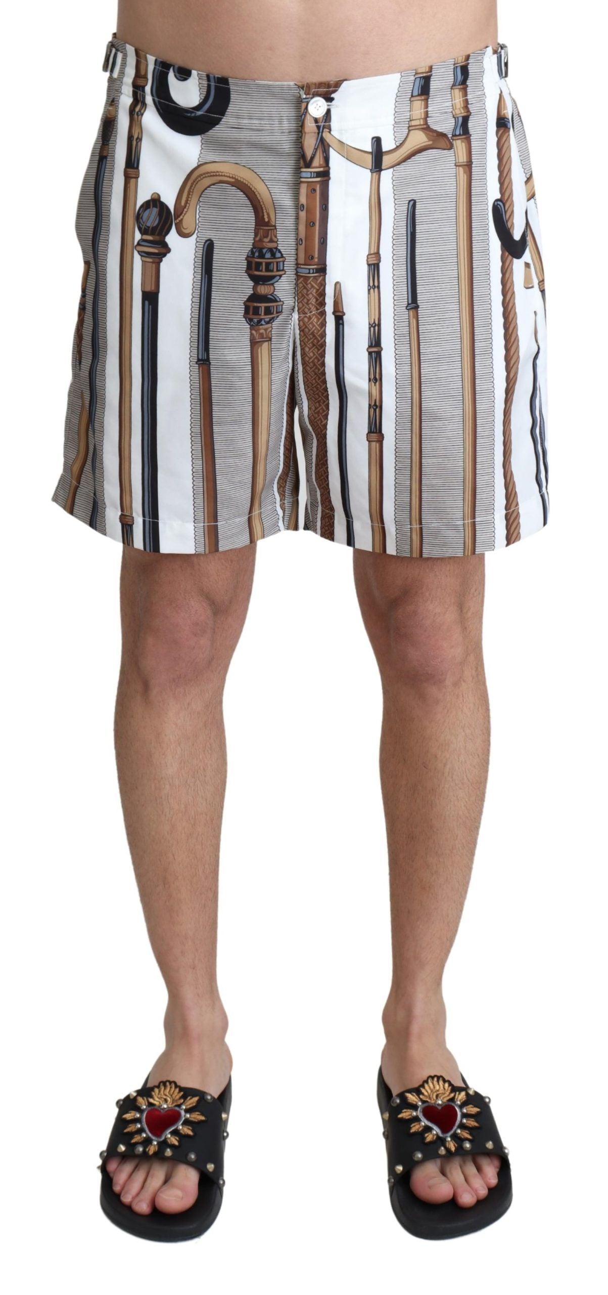 Men's patterned swim trunks with a design that includes tools and pipes