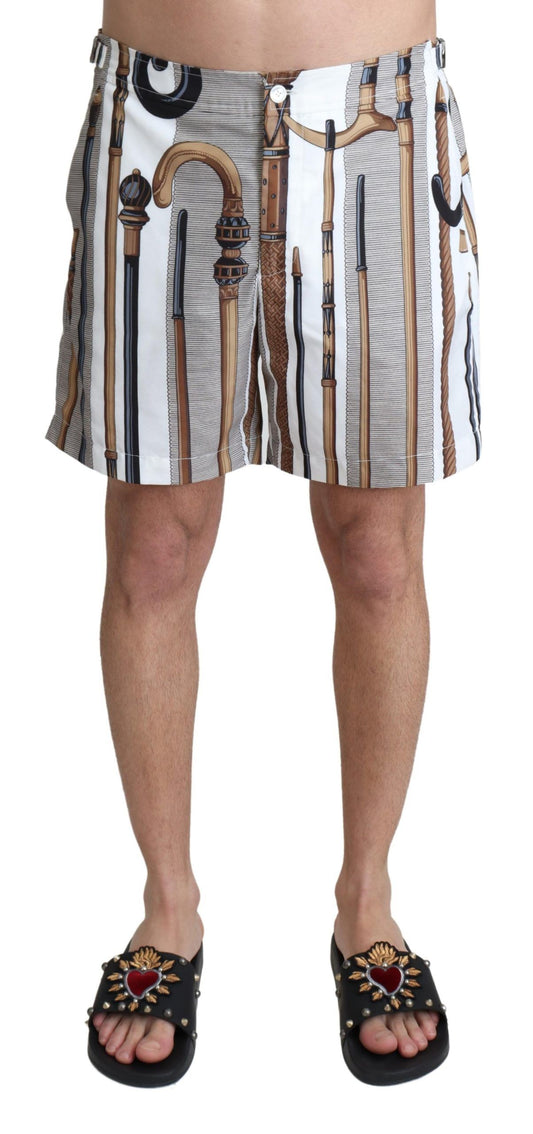 Men's patterned swim trunks with a design that includes tools and pipes