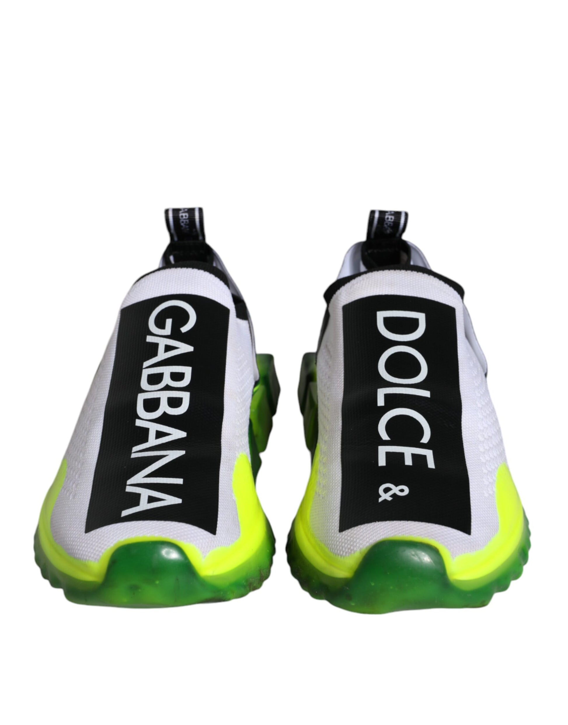Pair of white, yellow, and black slip-on shoes with brand name on side