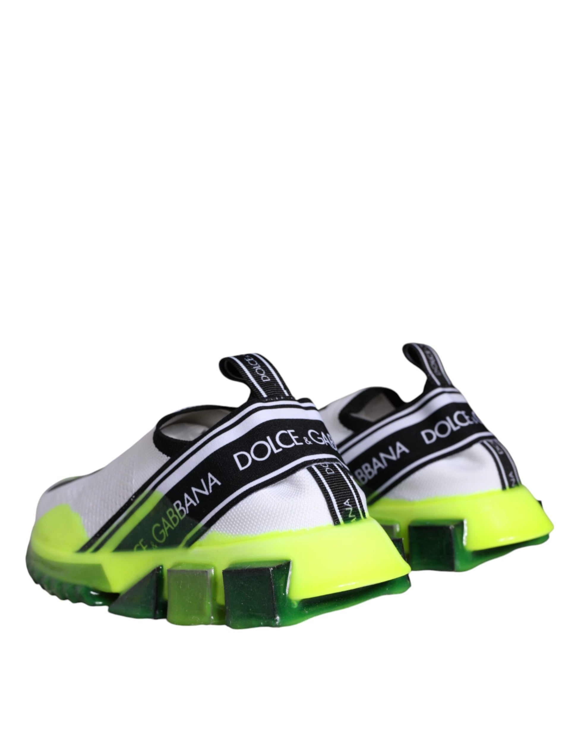 White and yellow slip-on shoes with black straps, featuring the Dolce & Gabbana logo