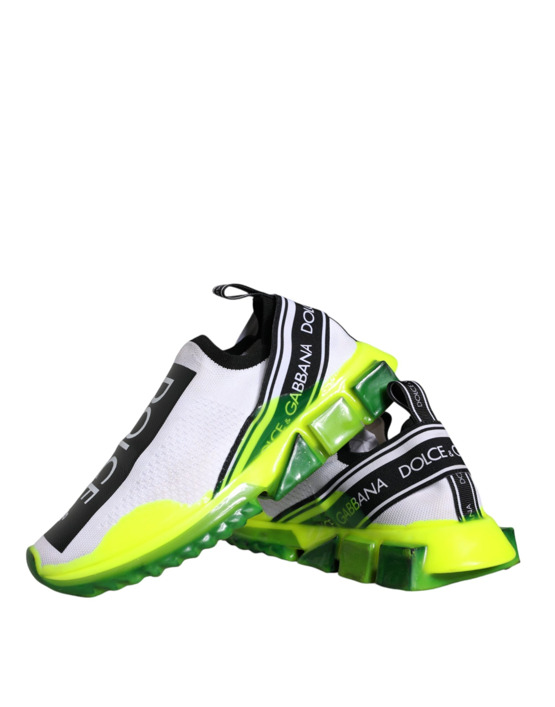 A pair of white, yellow, and black slip-on shoes with a branded logo