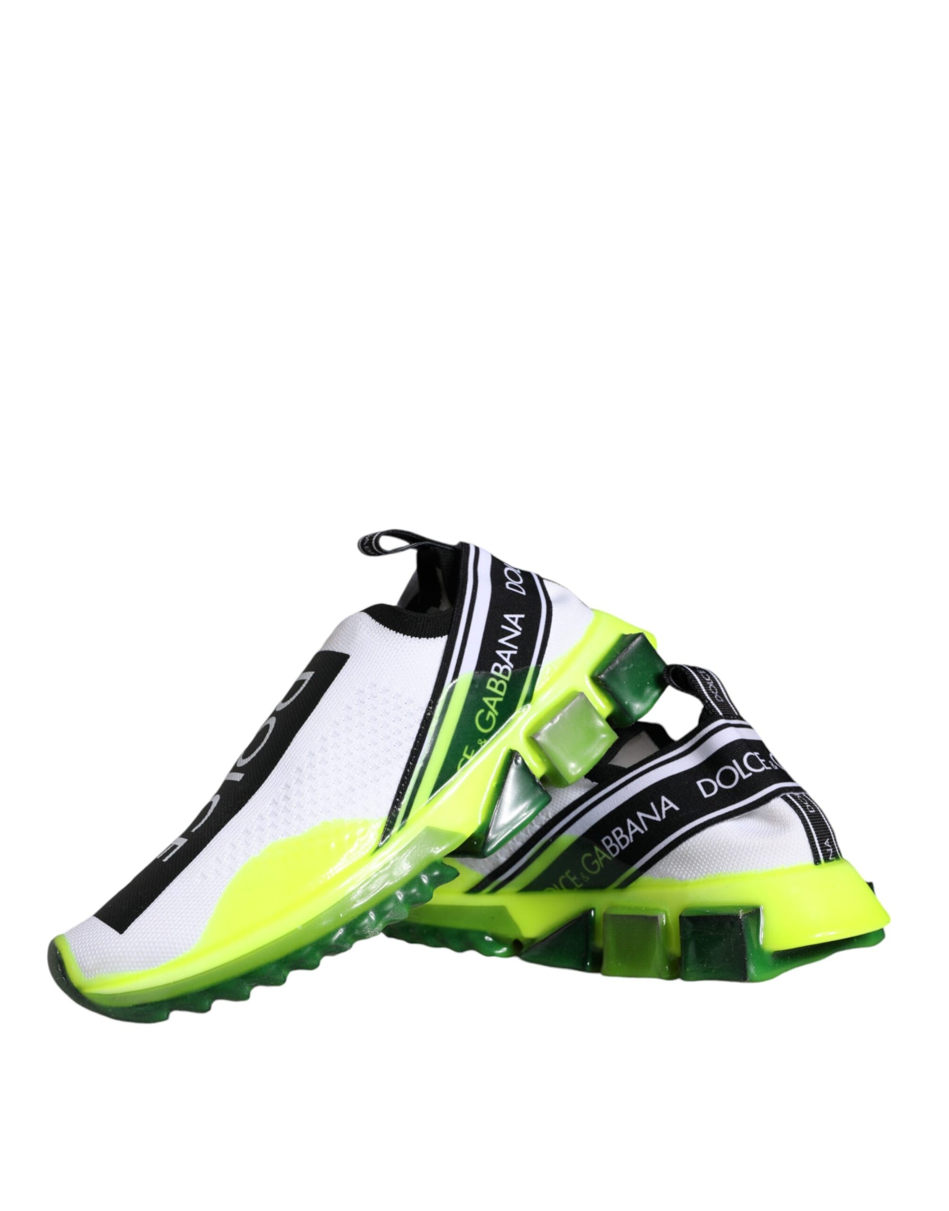 A pair of white and yellow slip-on shoes with a black stripe