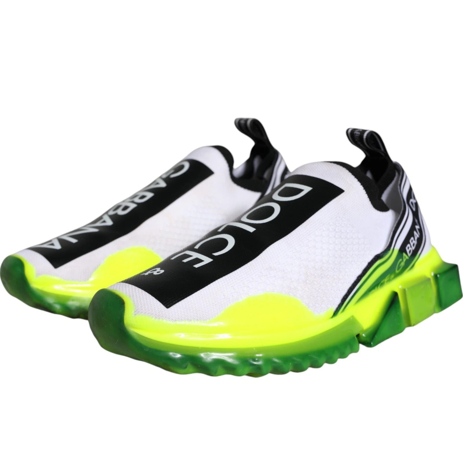 Pair of bright yellow and white sneakers with black laces
