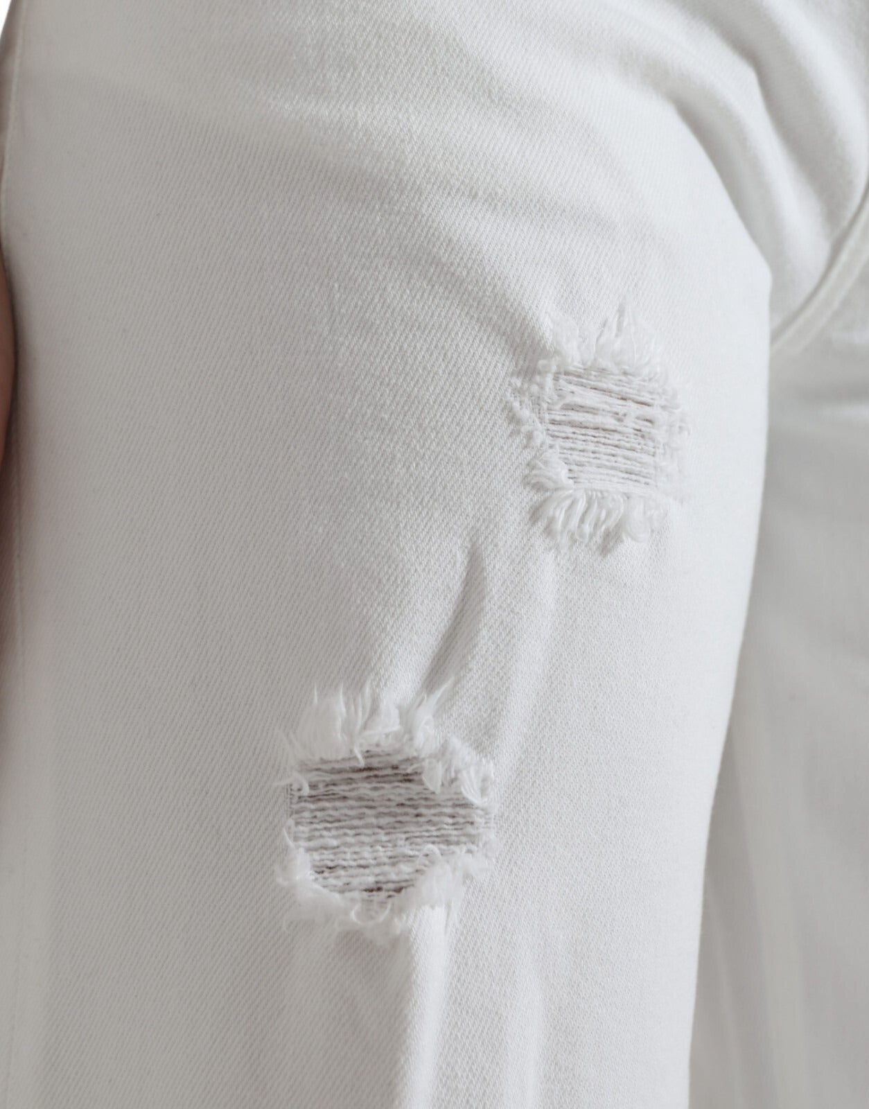White pants with holes on knees