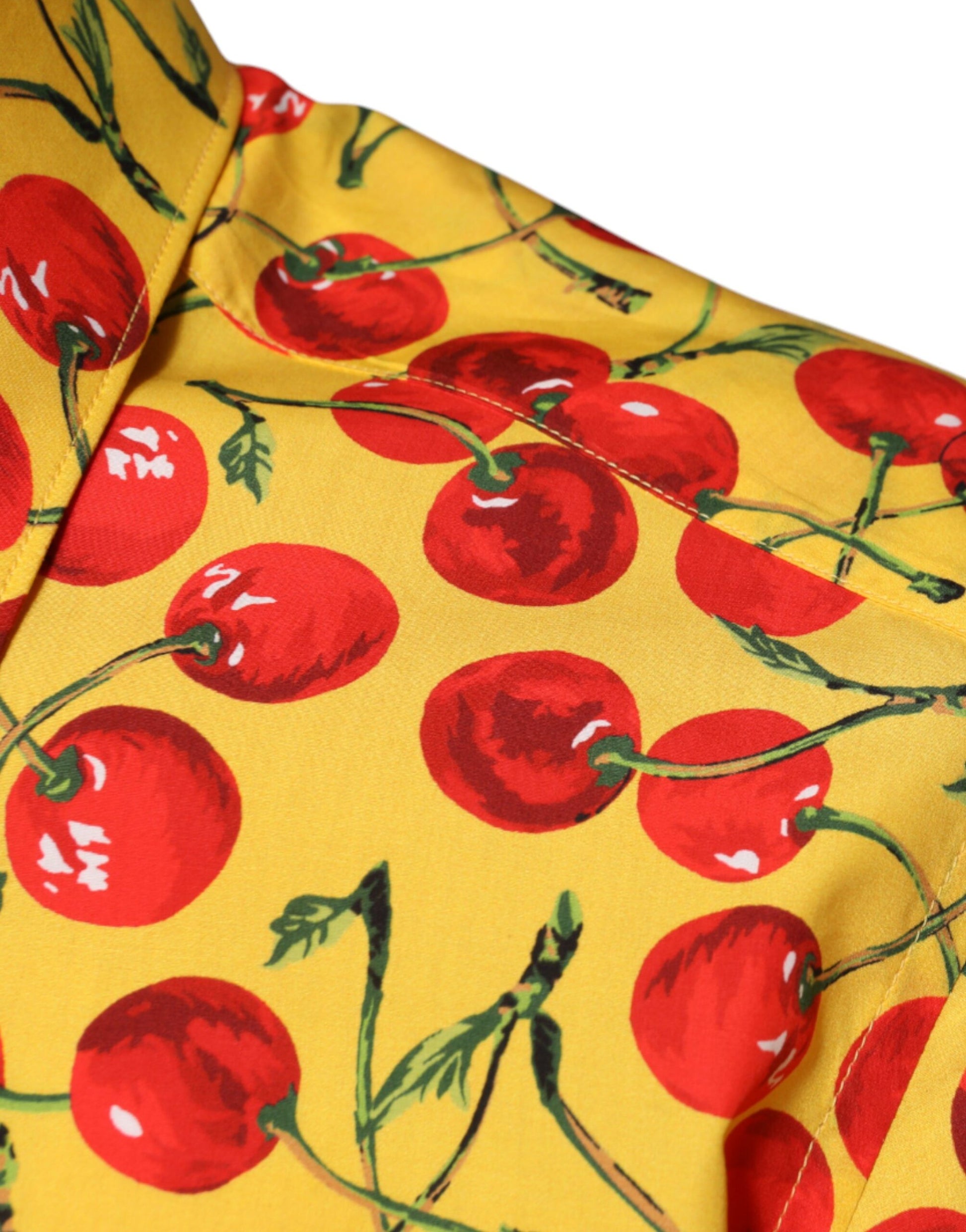 A yellow dress shirt with a pattern of red cherries and green stems