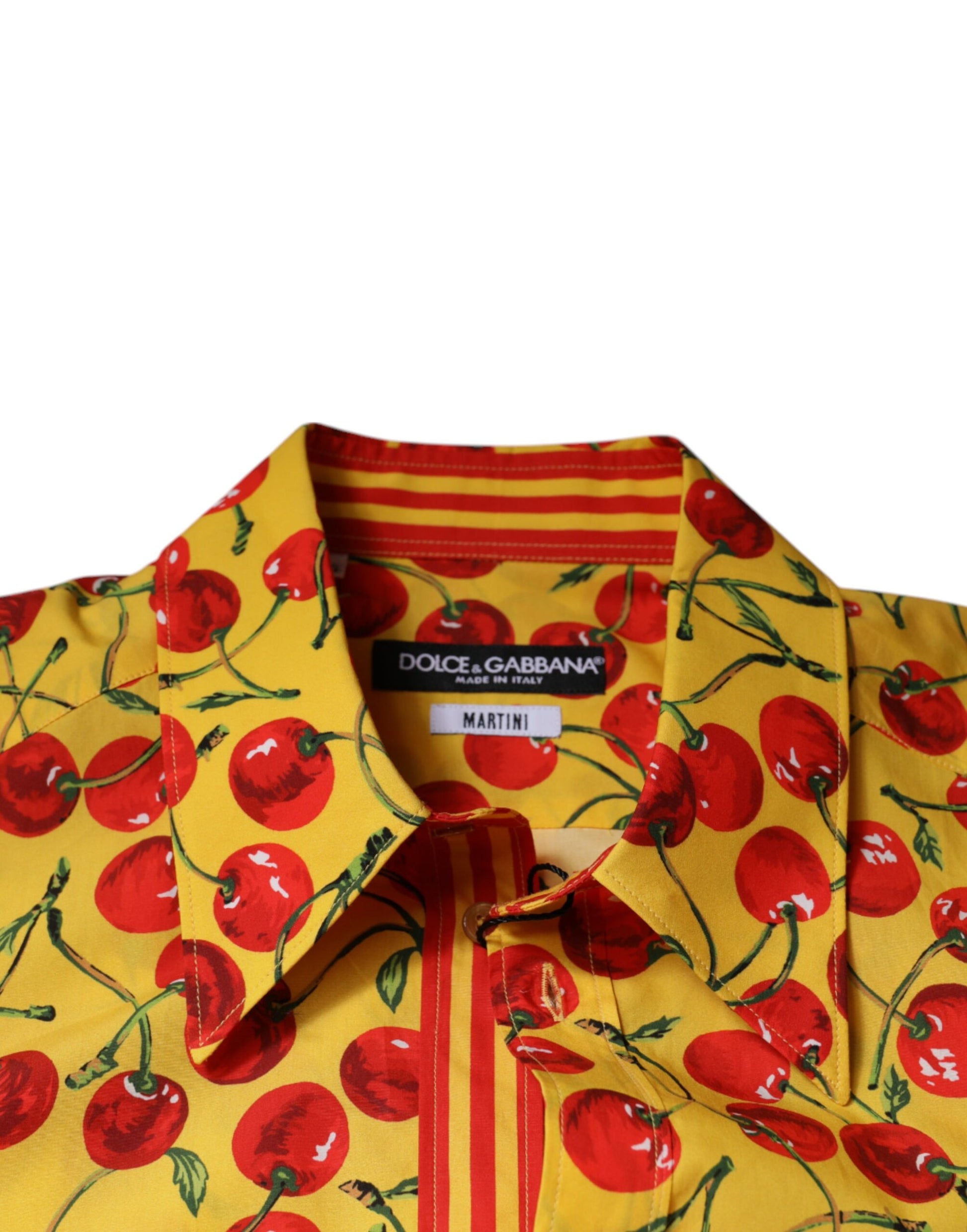A yellow shirt with a cherry print and red trim