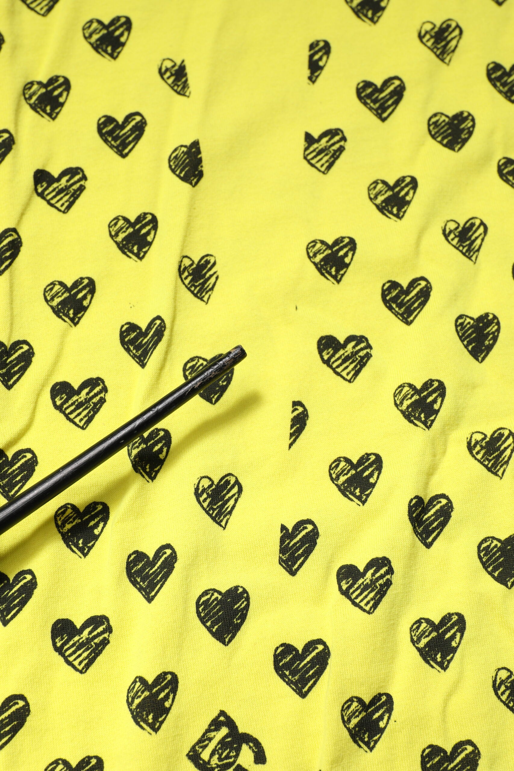 Yellow fabric with black hearts pattern