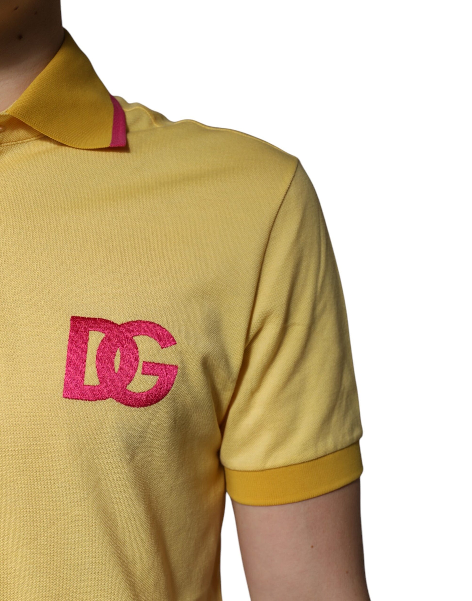 Yellow polo shirt with pink logo on left chest