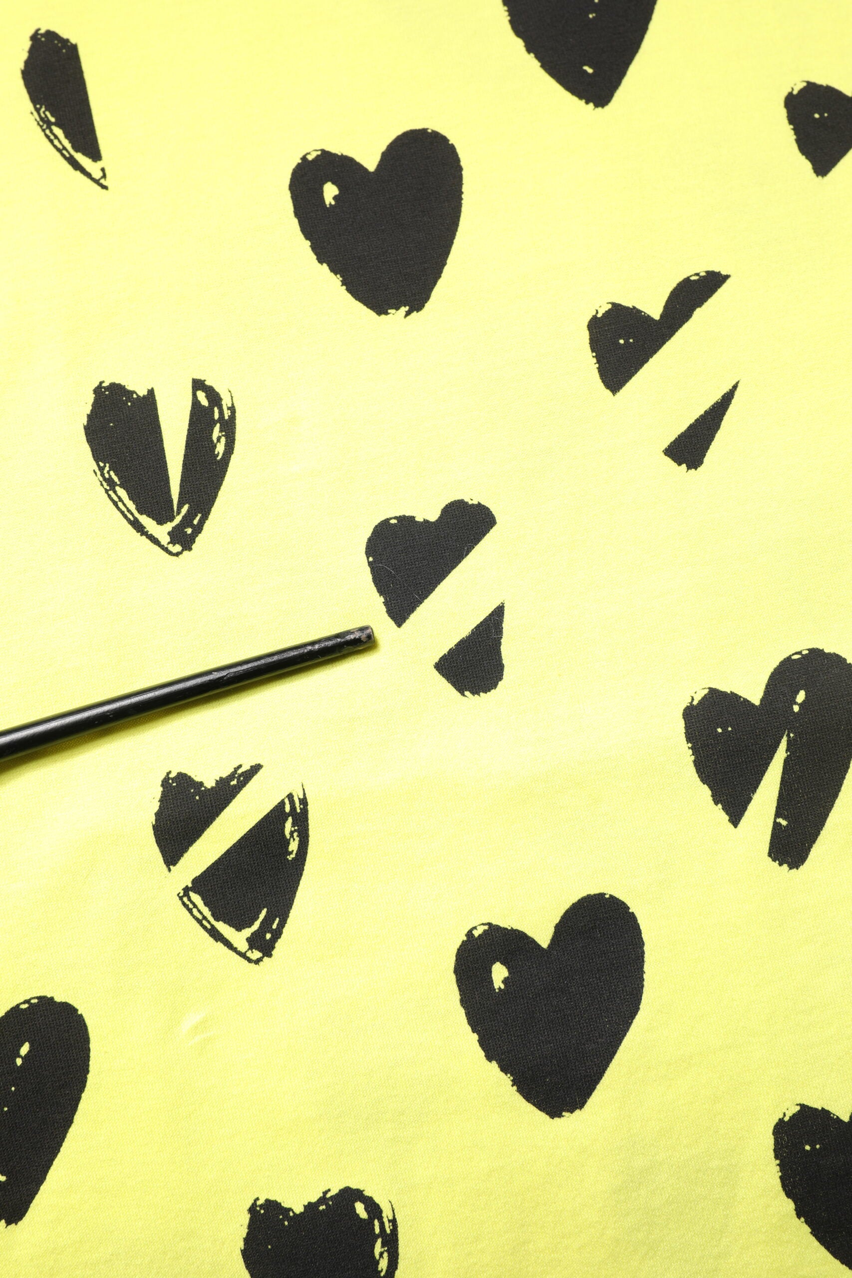 Black hearts on yellow fabric