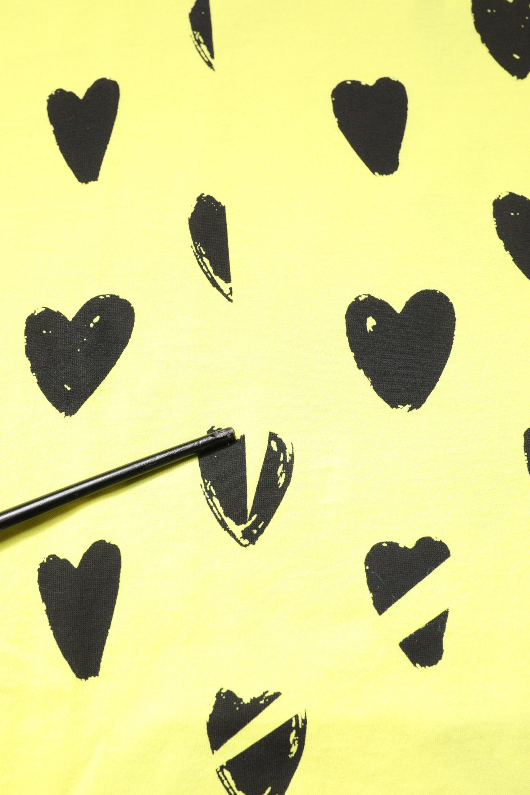 Black ink hearts on yellow background