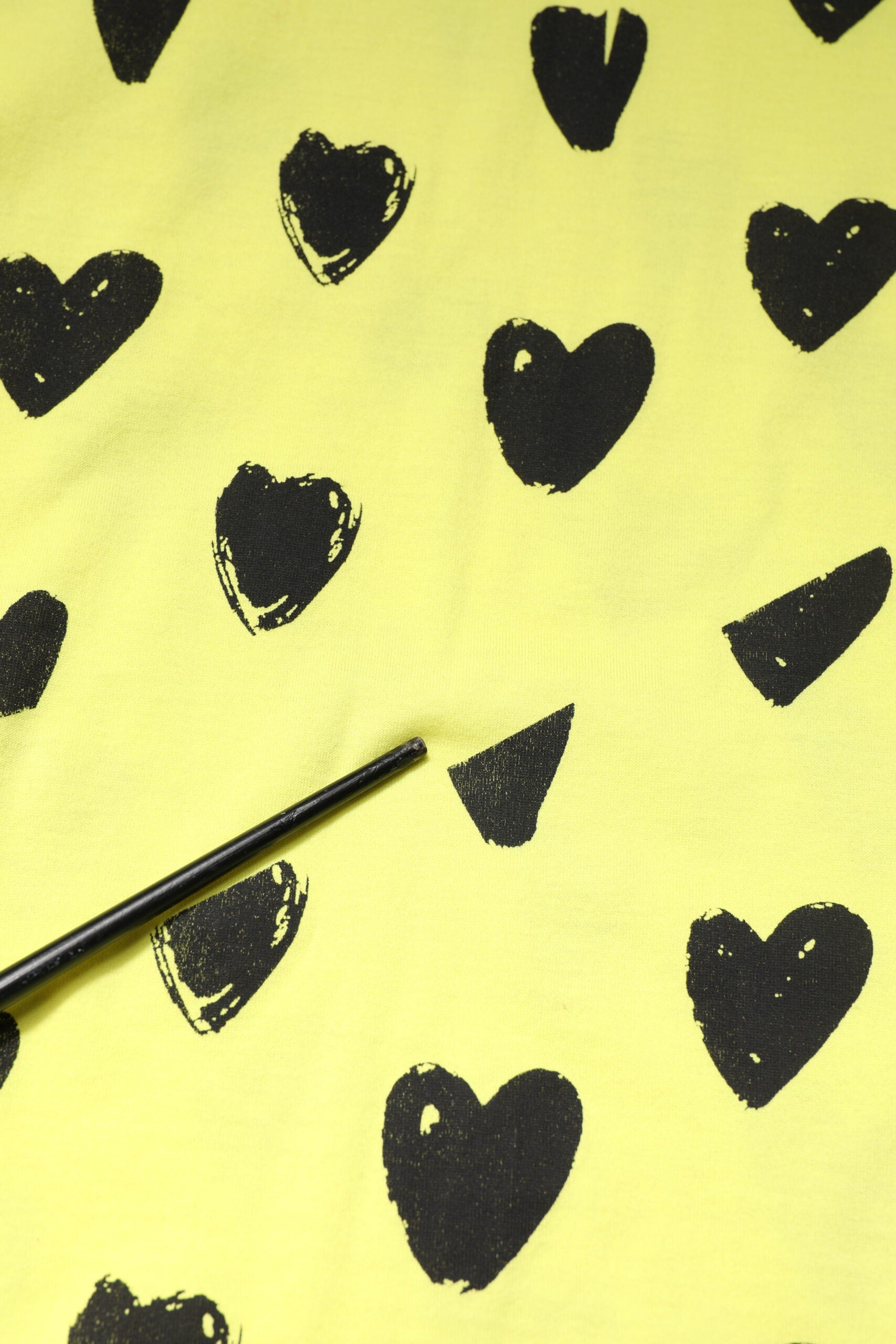 Yellow fabric with black hearts