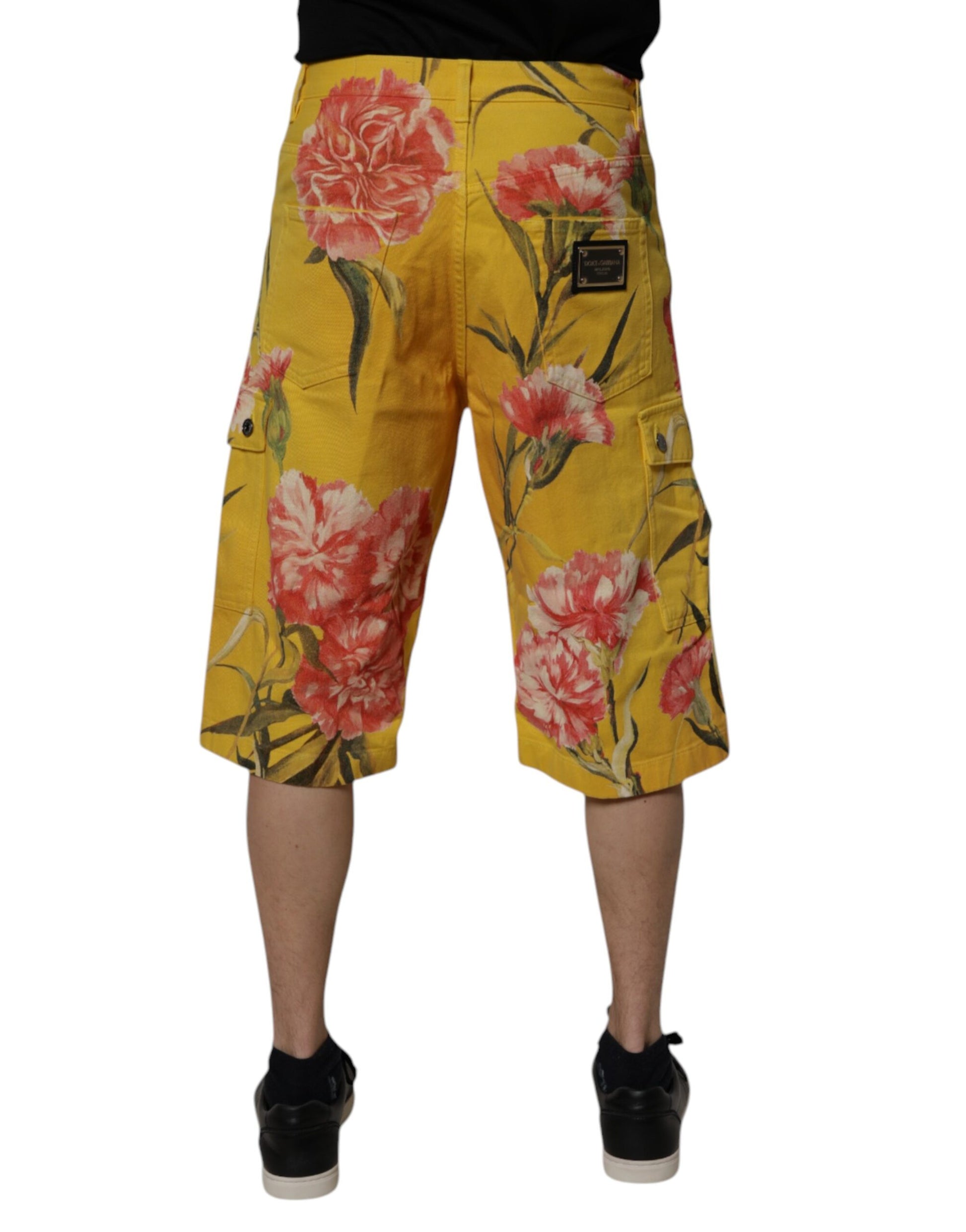 A pair of yellow floral cargo denim shorts with a poppy flower pattern