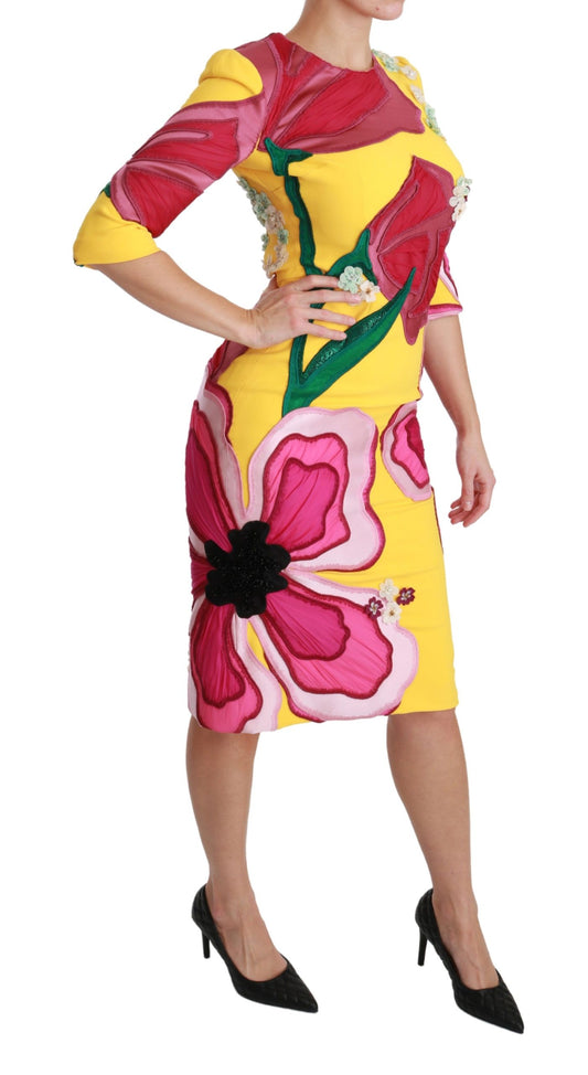 A yellow floral crystal bodycon sheath dress with a fitted silhouette, featuring a vibrant flower print and embellished with