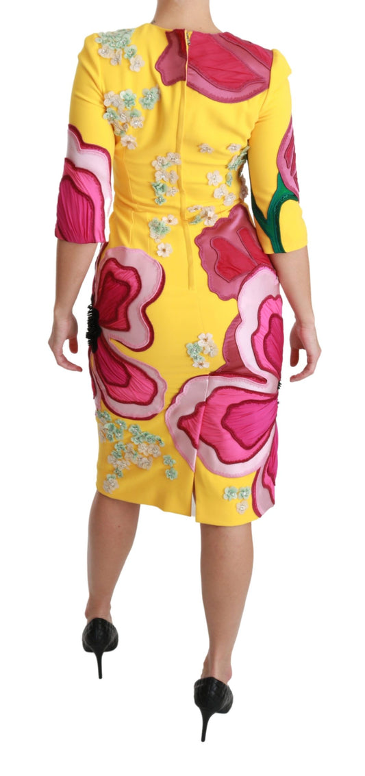 A yellow floral dress with crystals on a mannequin
