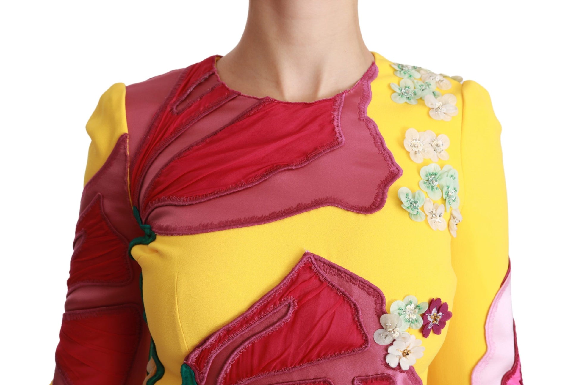 A yellow floral crystal bodycon sheath dress with a v-neckline