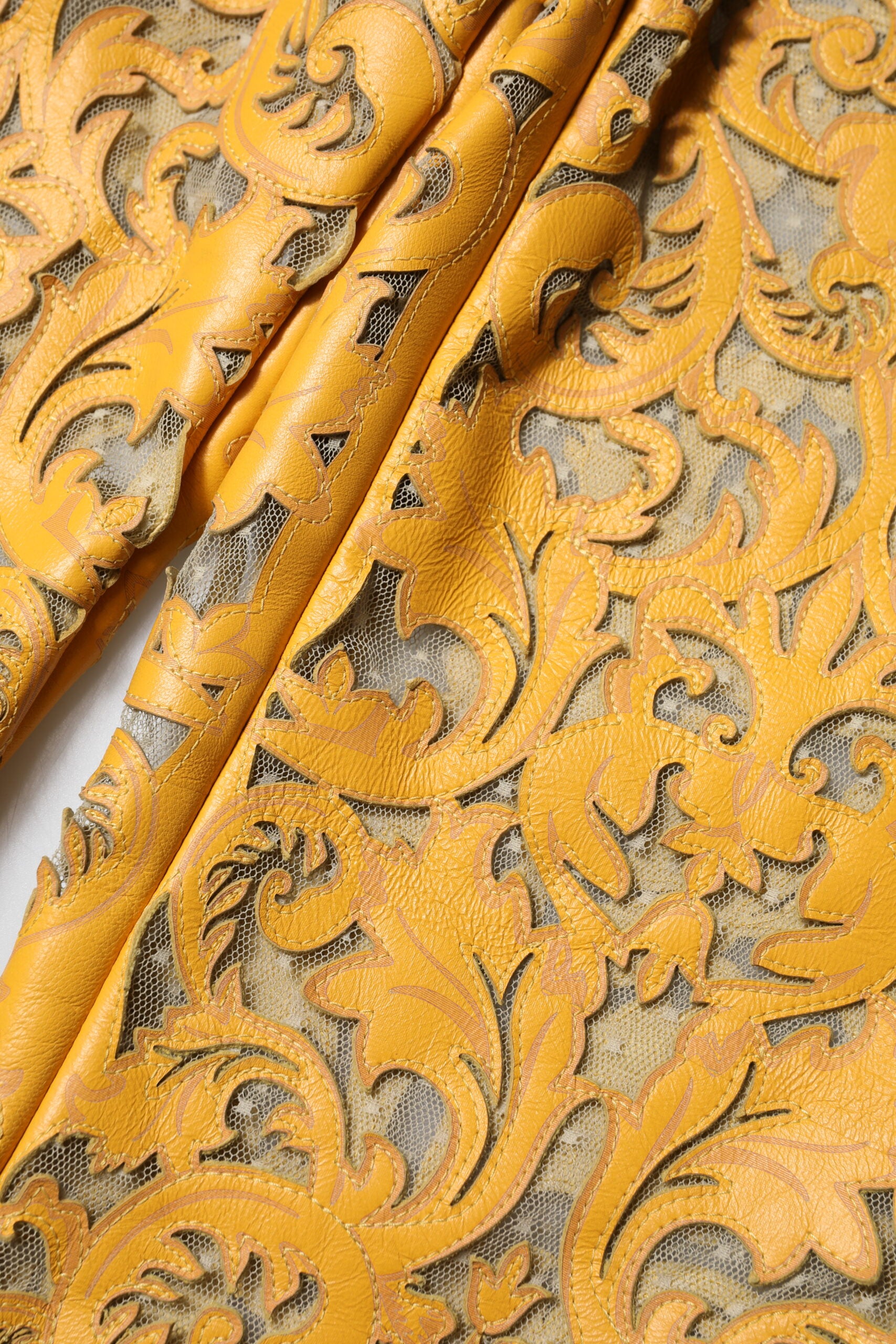 Yellow embroidered fabric with intricate designs