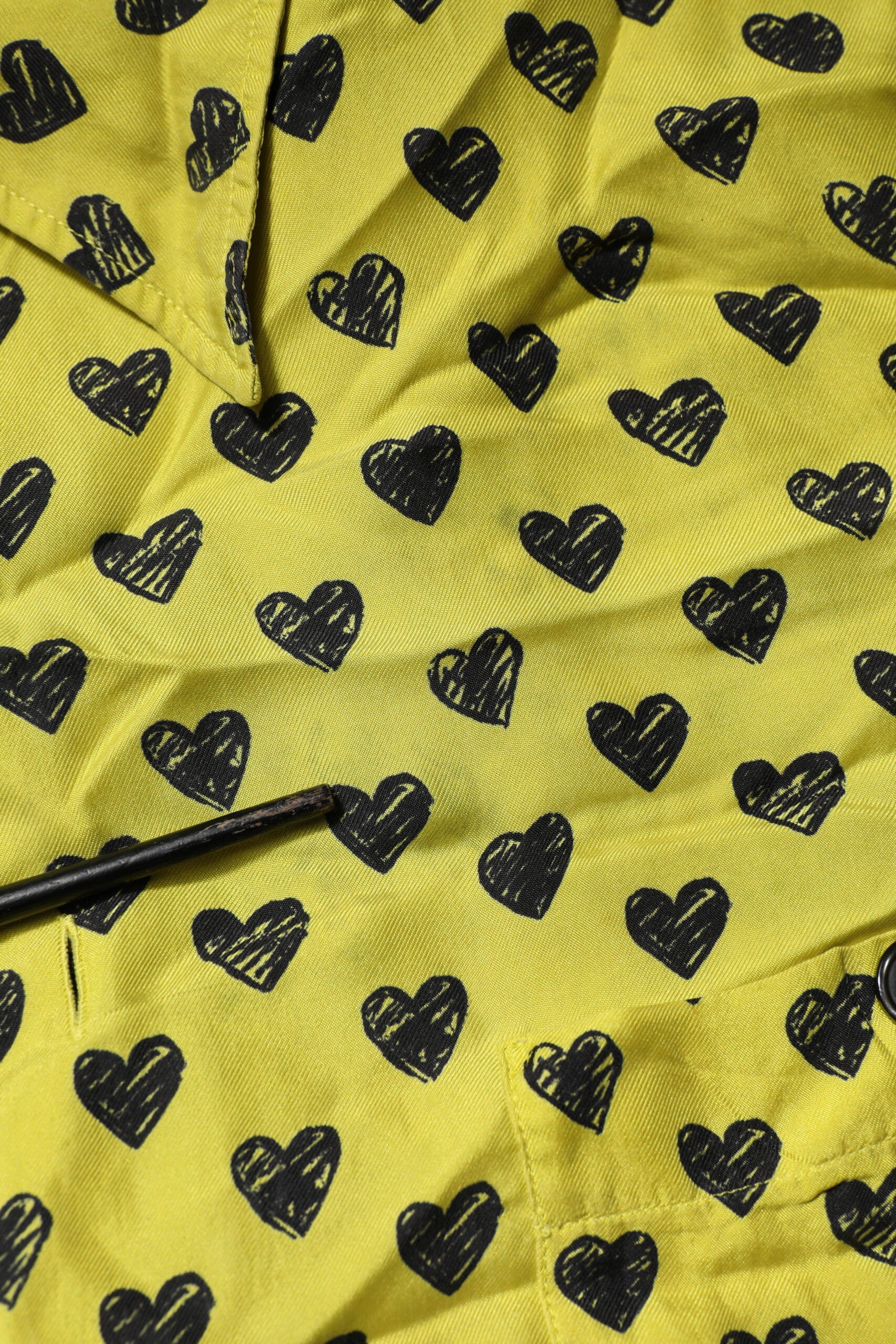 Yellow fabric with black hearts pattern