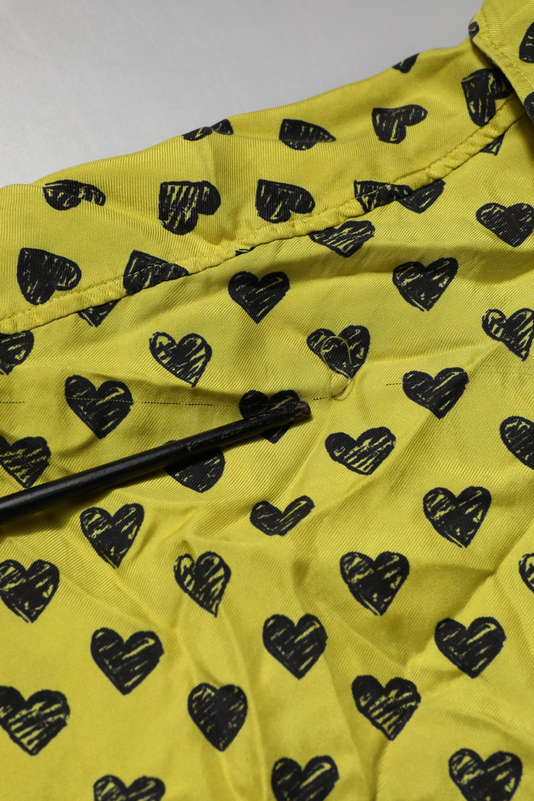 Yellow shirt with black hearts pattern