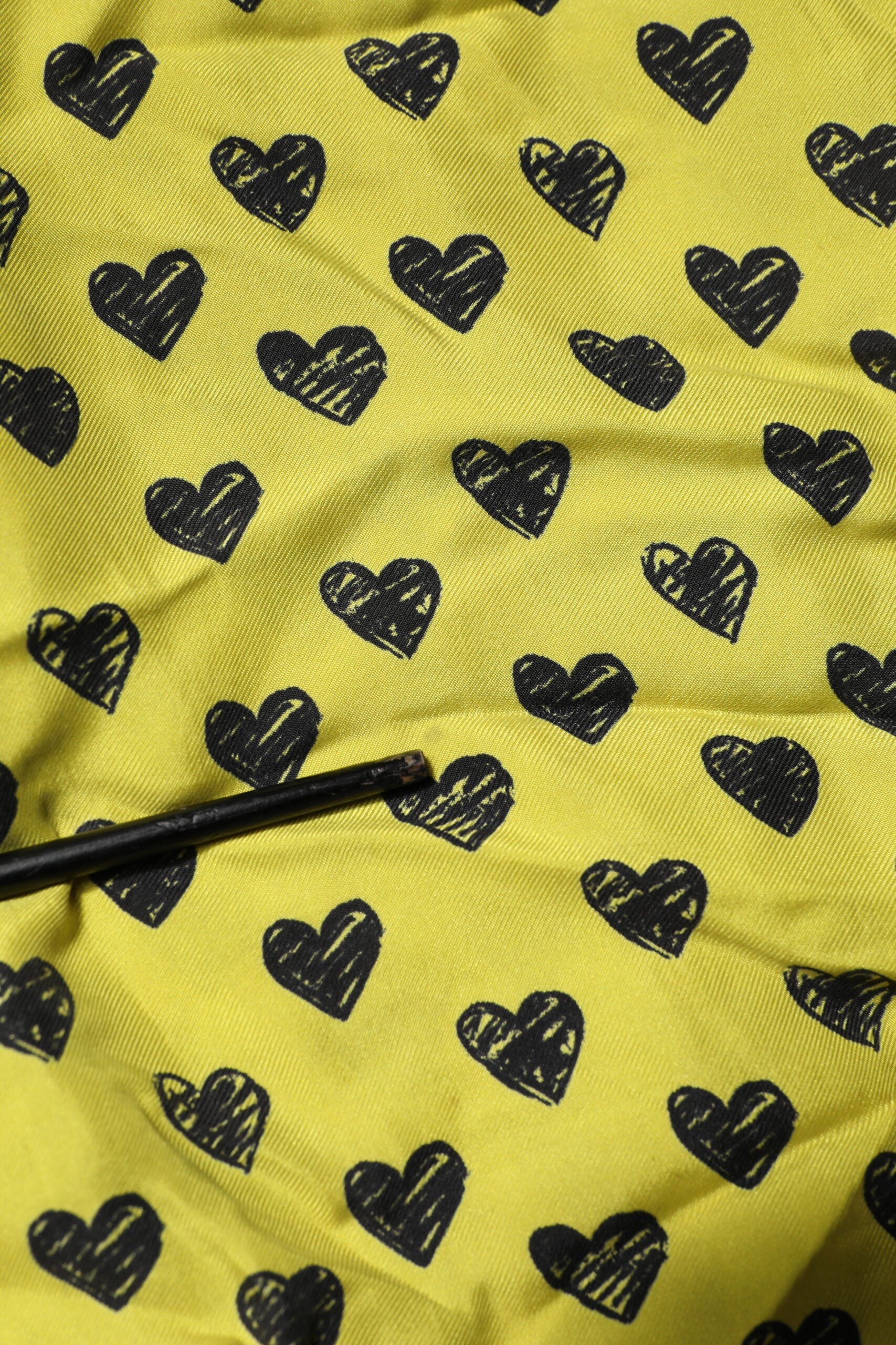 Yellow fabric with black hearts pattern