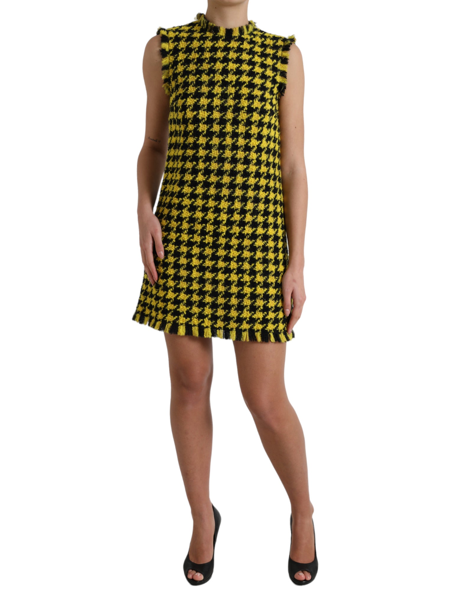 A sleeveless, yellow houndstooth mini dress with a V-neckline