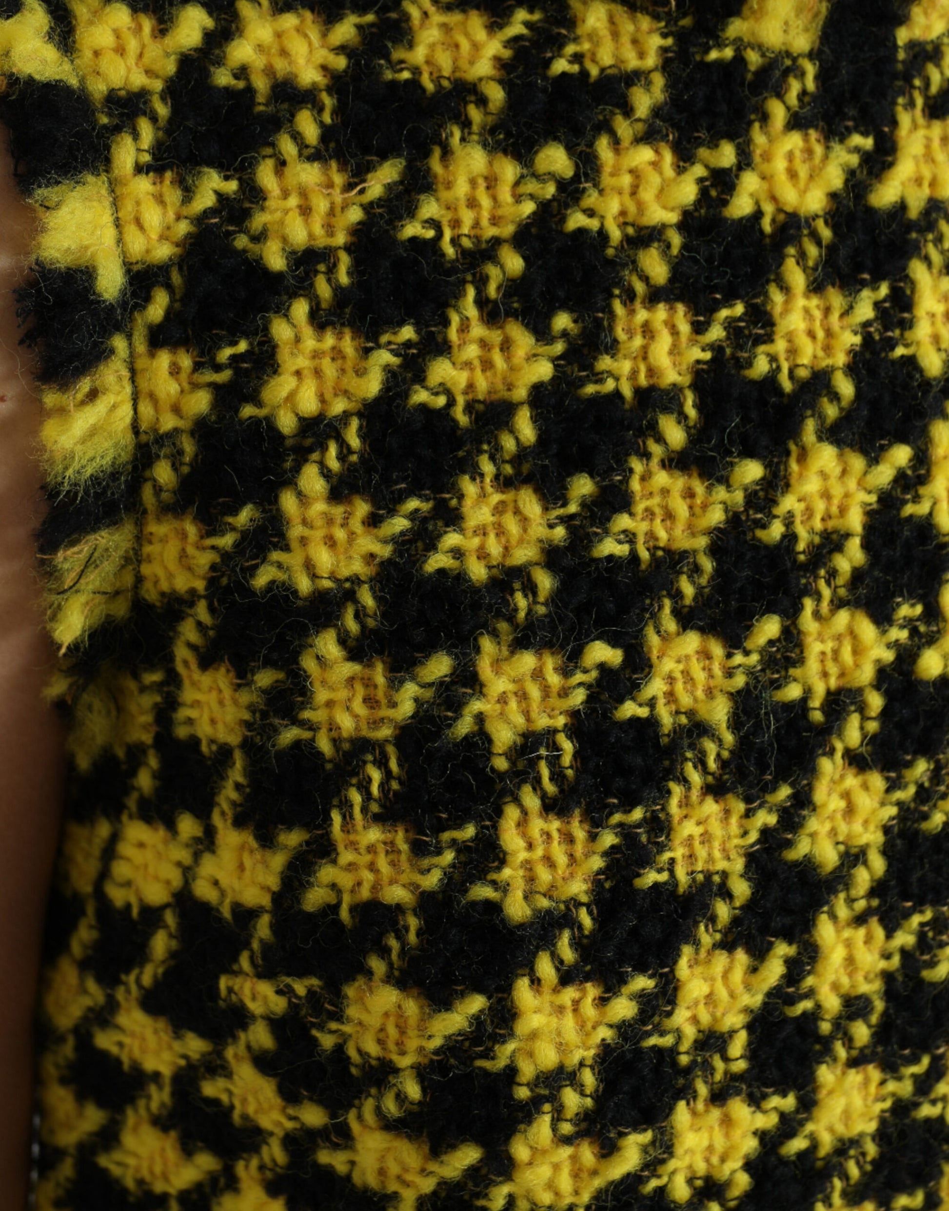 A yellow houndstooth patterned sleeveless aline mini dress
