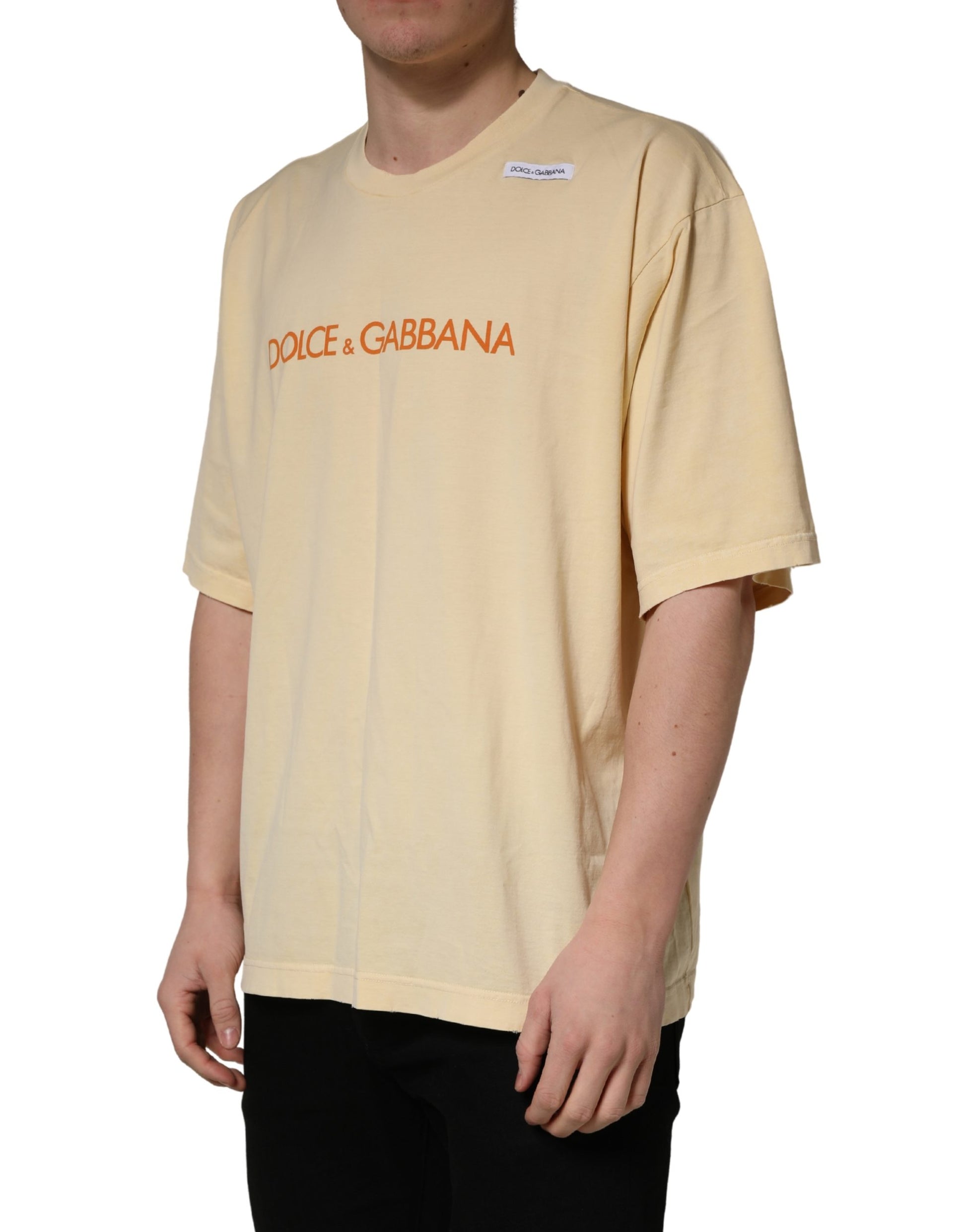 A yellow crew neck t-shirt with a logo print on the front