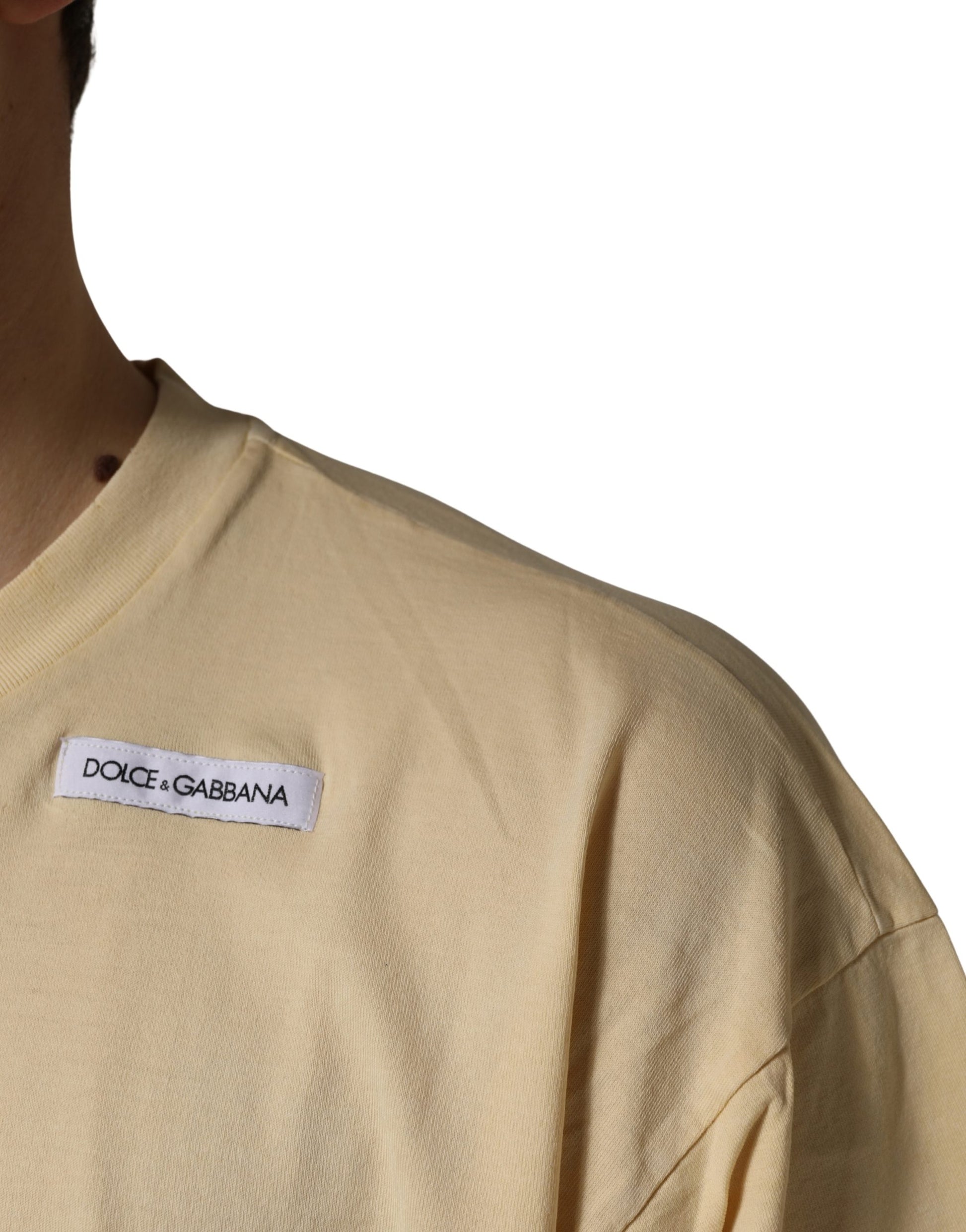 A yellow crew neck t-shirt with a logo print on the left chest