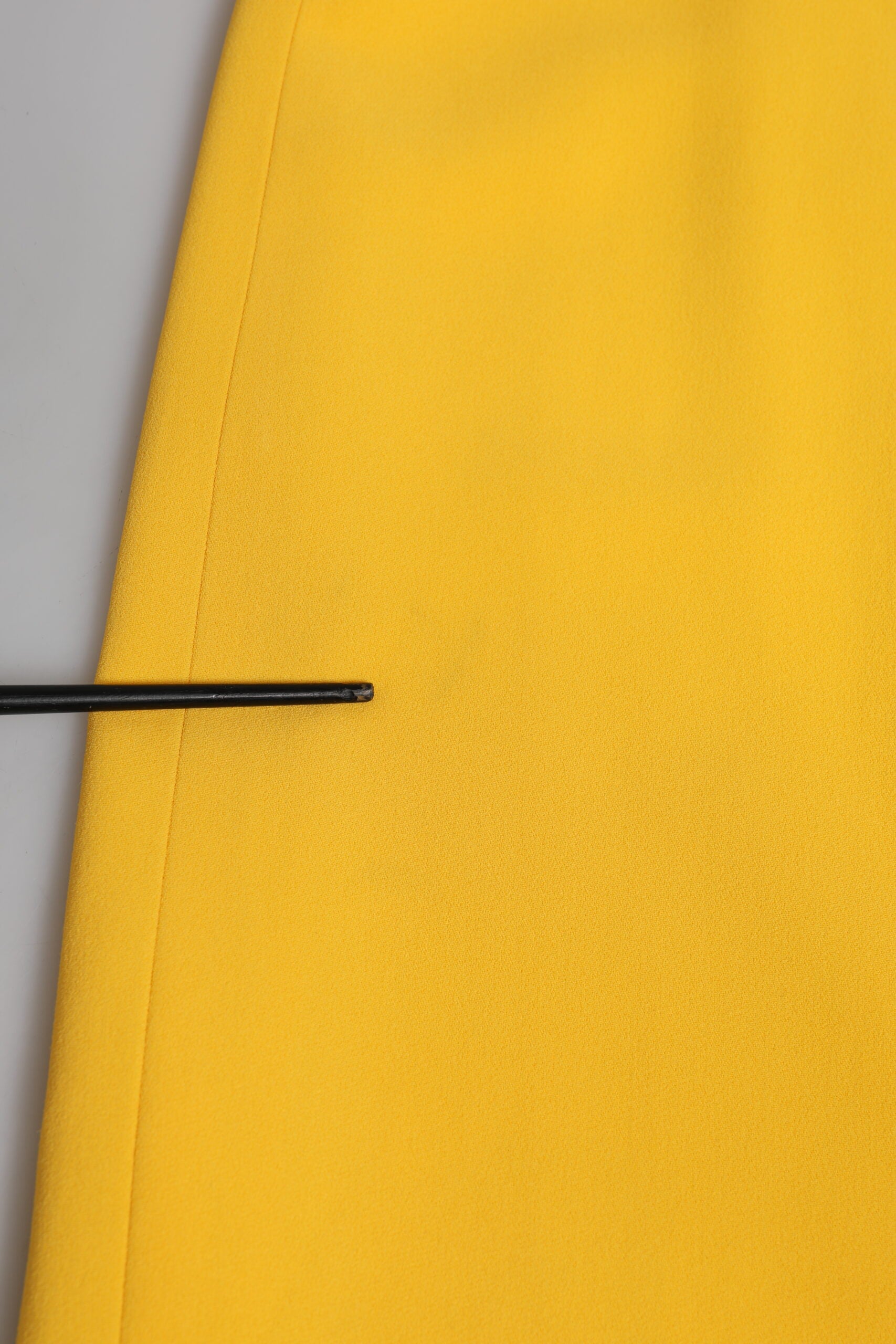 Yellow fabric with black pin