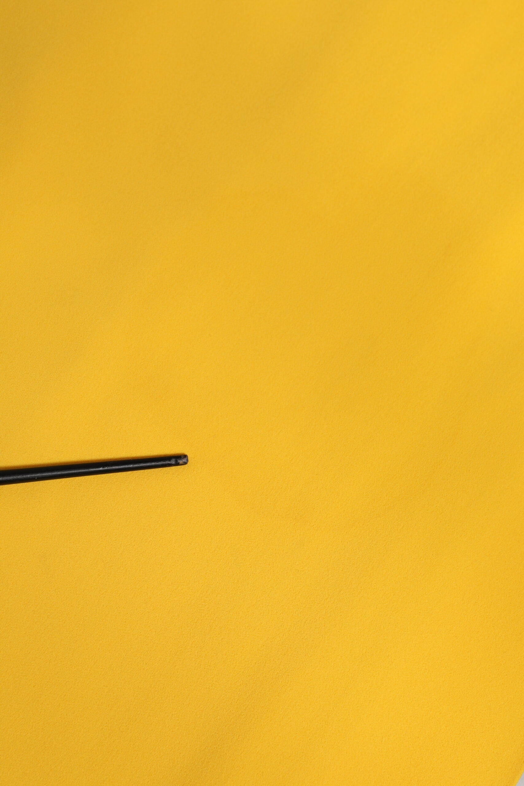 Black pen on yellow fabric