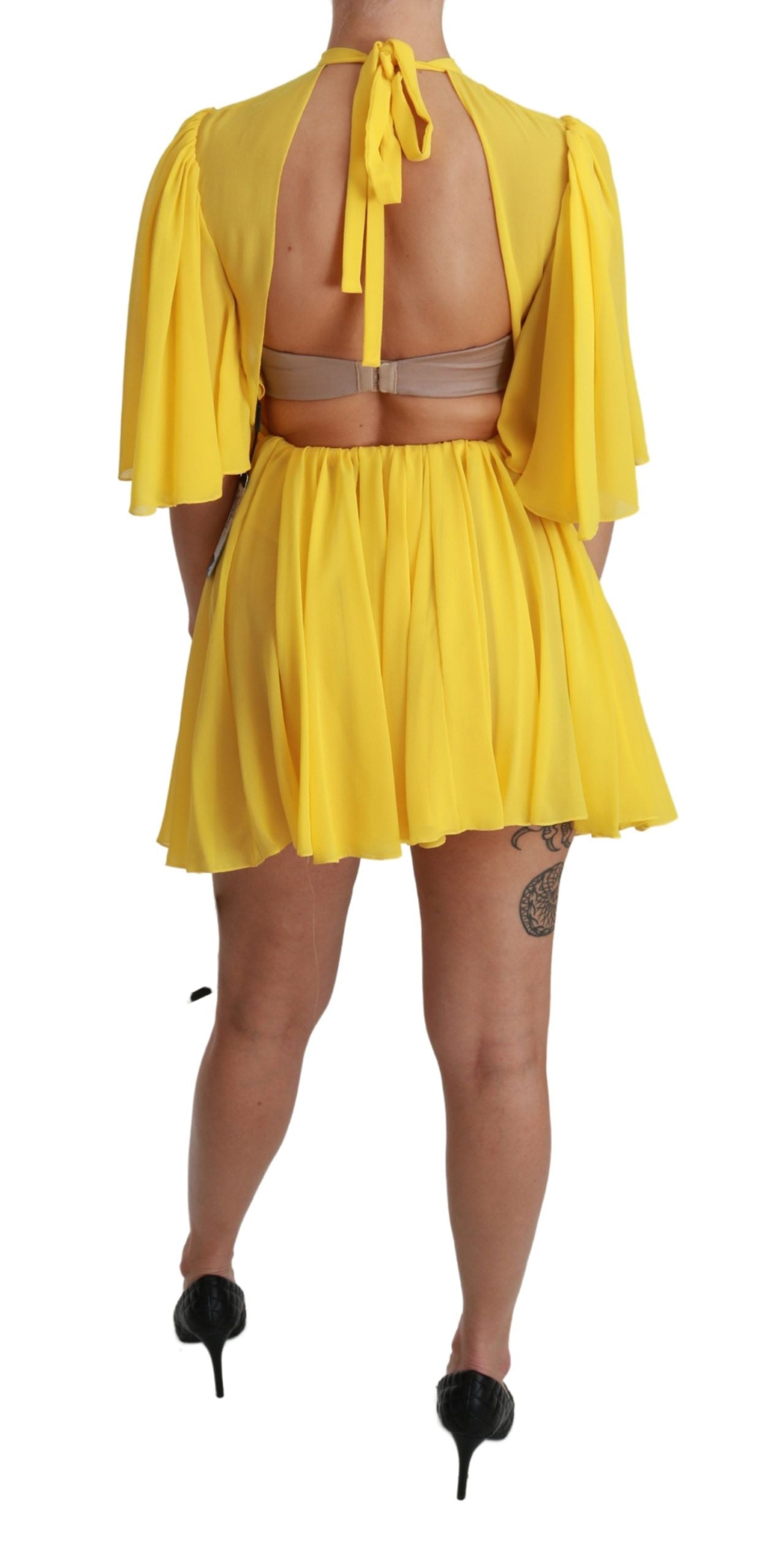 Yellow pleated mini dress with backless design, made of silk