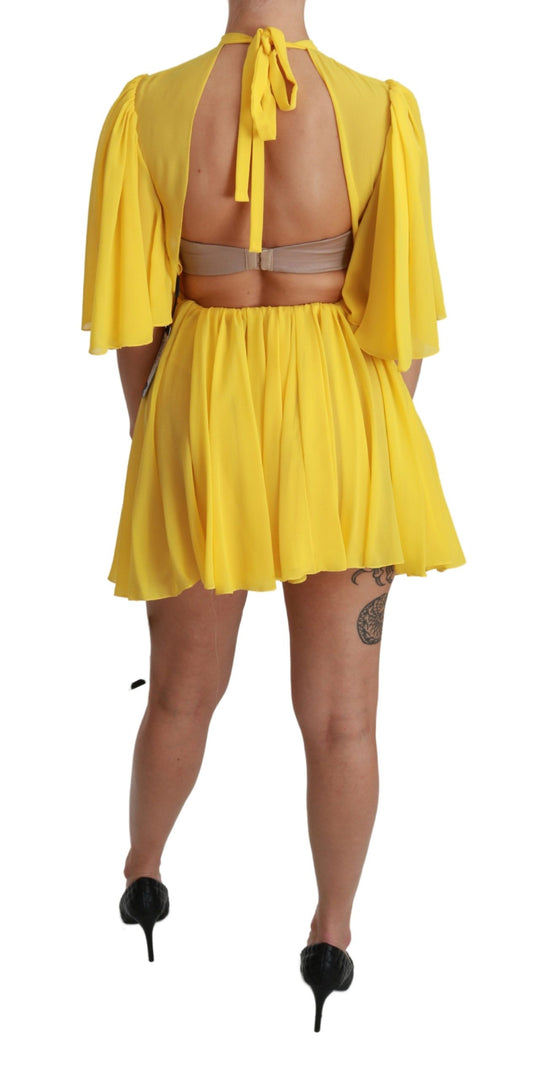 Yellow pleated mini dress with backless design, made of silk