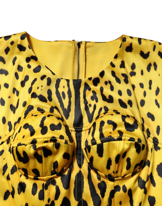 A yellow leopard print midi dress with a sheath silhouette and two pockets