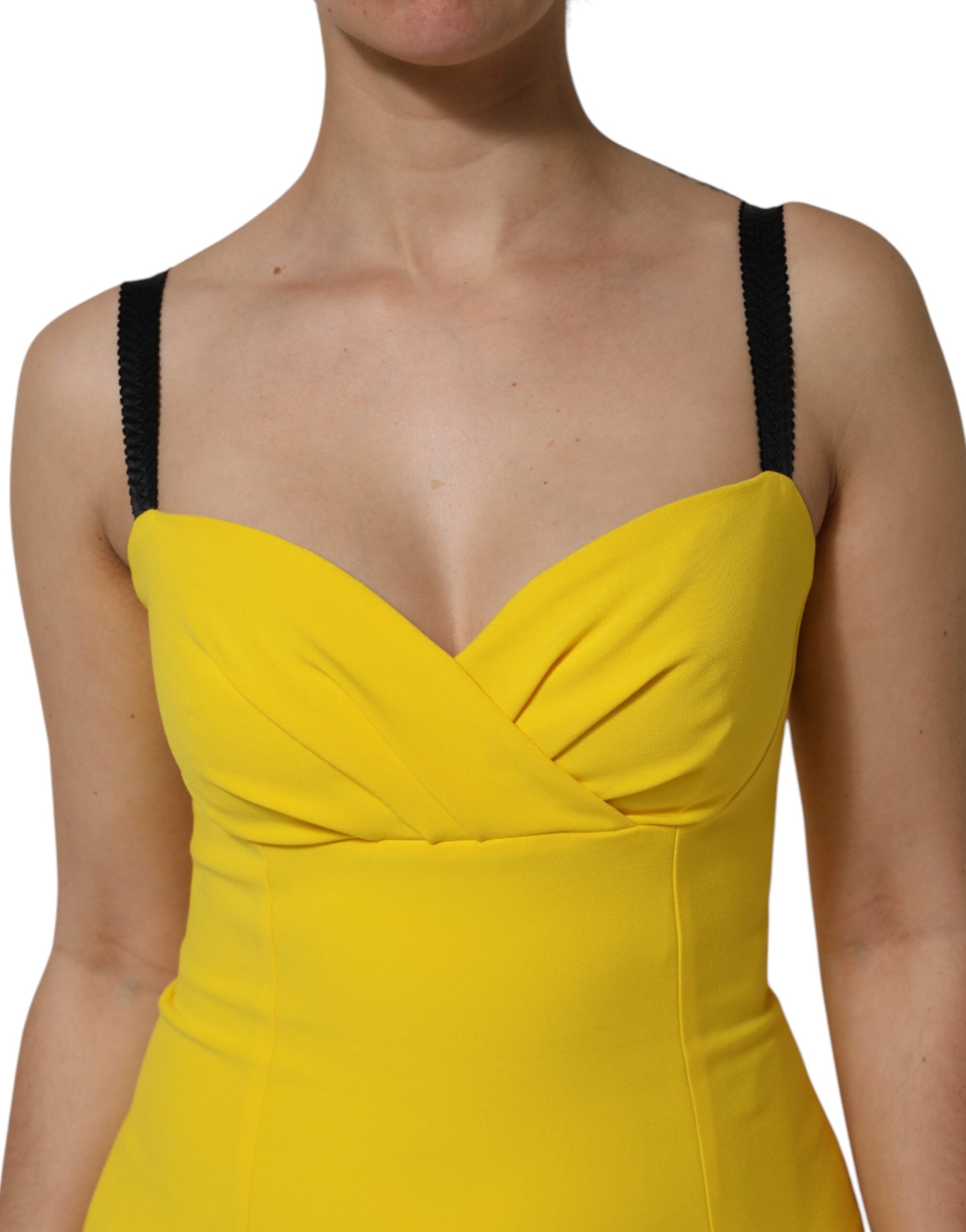 A yellow sleeveless sheath midi dress with ruched detailing