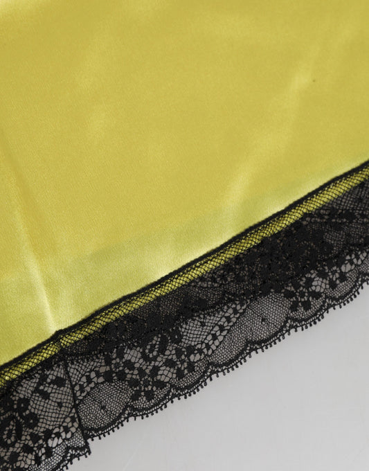 A pair of yellow satin silk mid waist underwear shorts with black lace trim