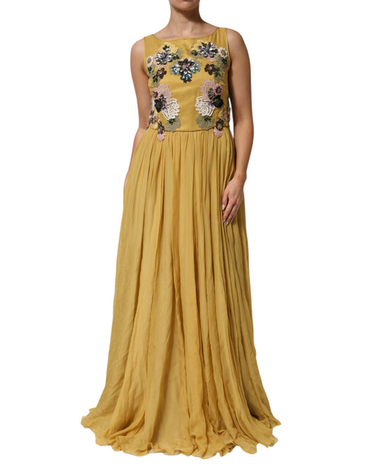 A long yellow silk dress with floral embroidery and ruffles at the bottom