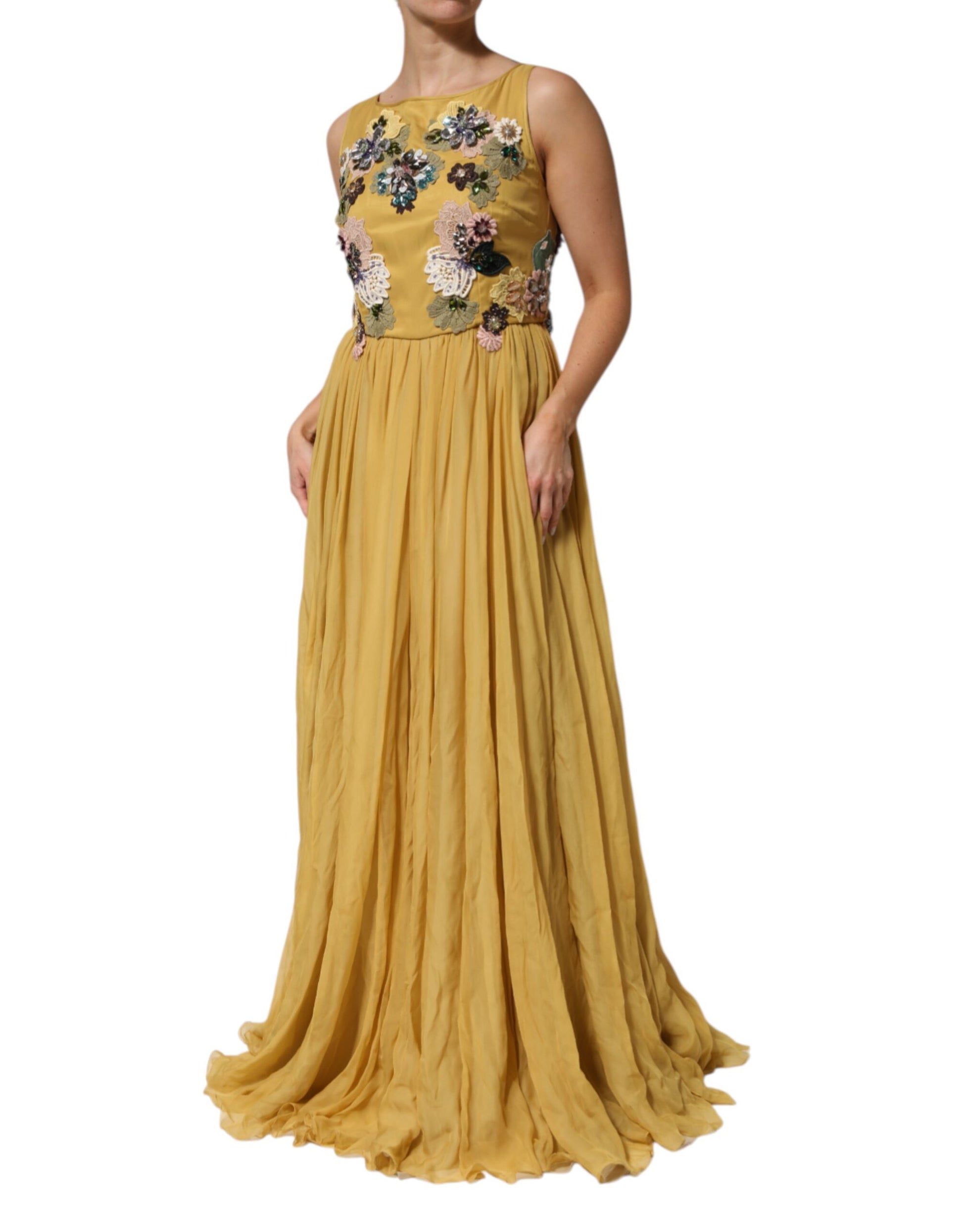 A long yellow silk dress with floral embroidery and a flowing skirt