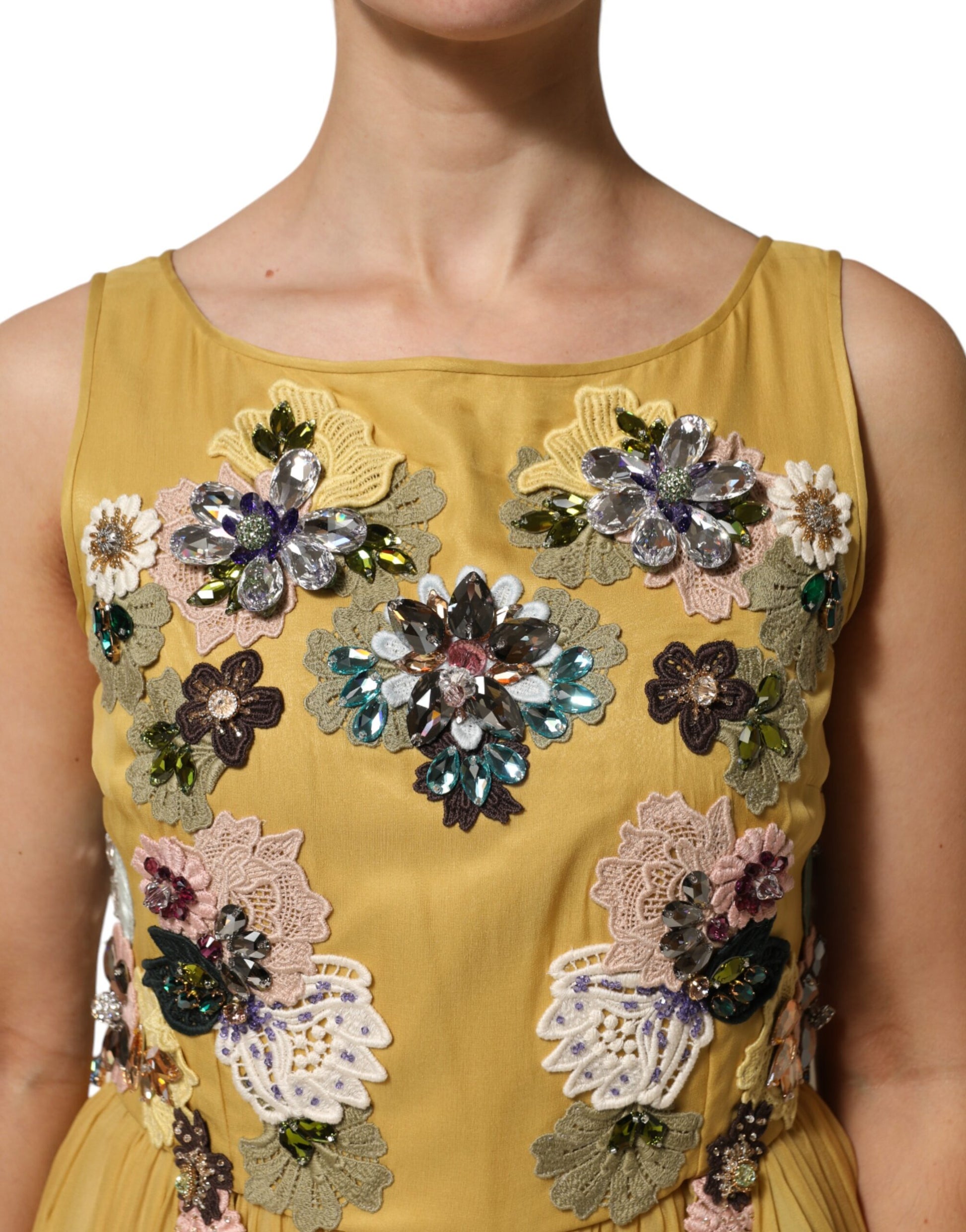 A yellow silk dress with floral embroidery and sequins, featuring a V-neckline