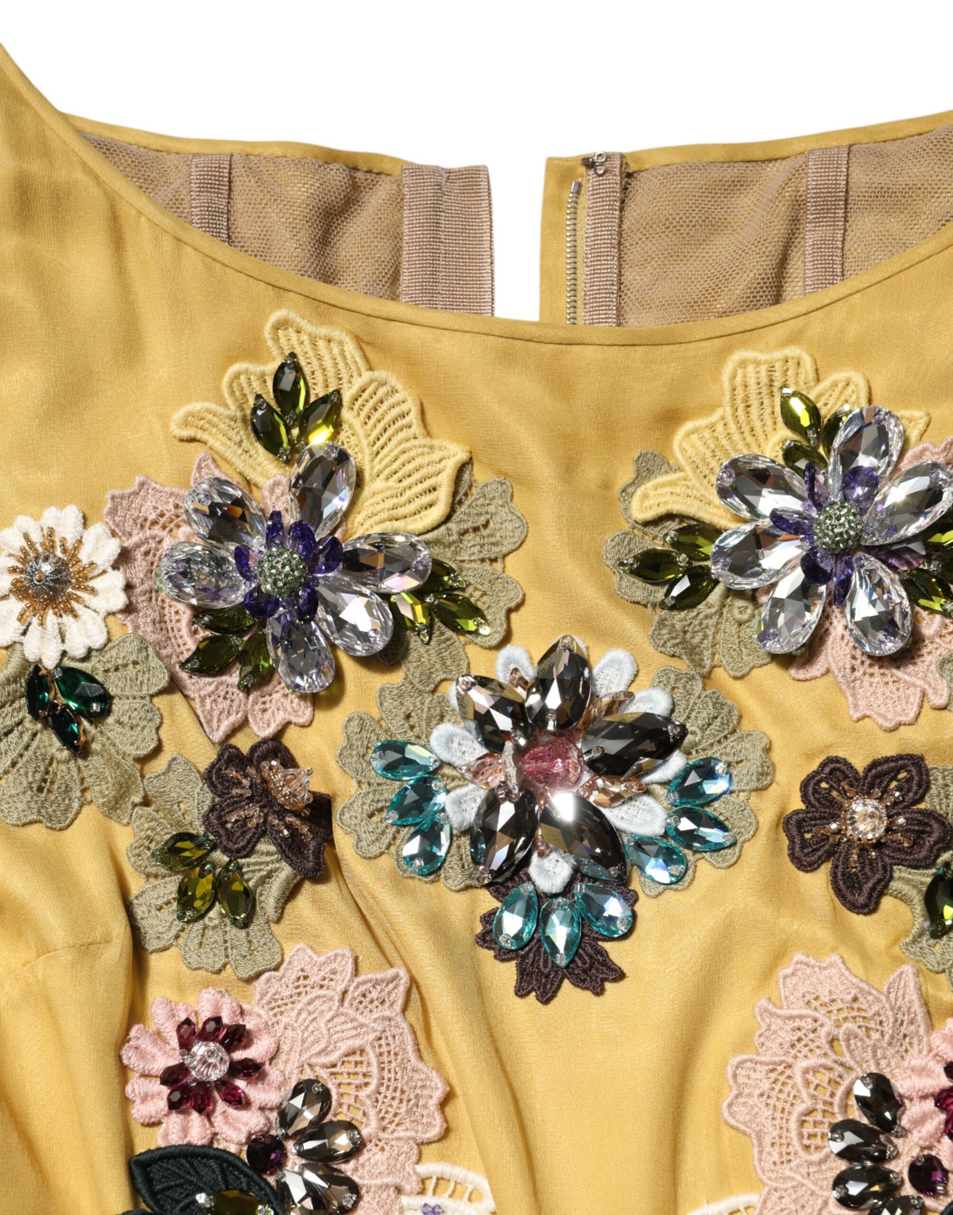 A yellow silk dress with floral embroidery and sequins, featuring a high neckline and long sleeves