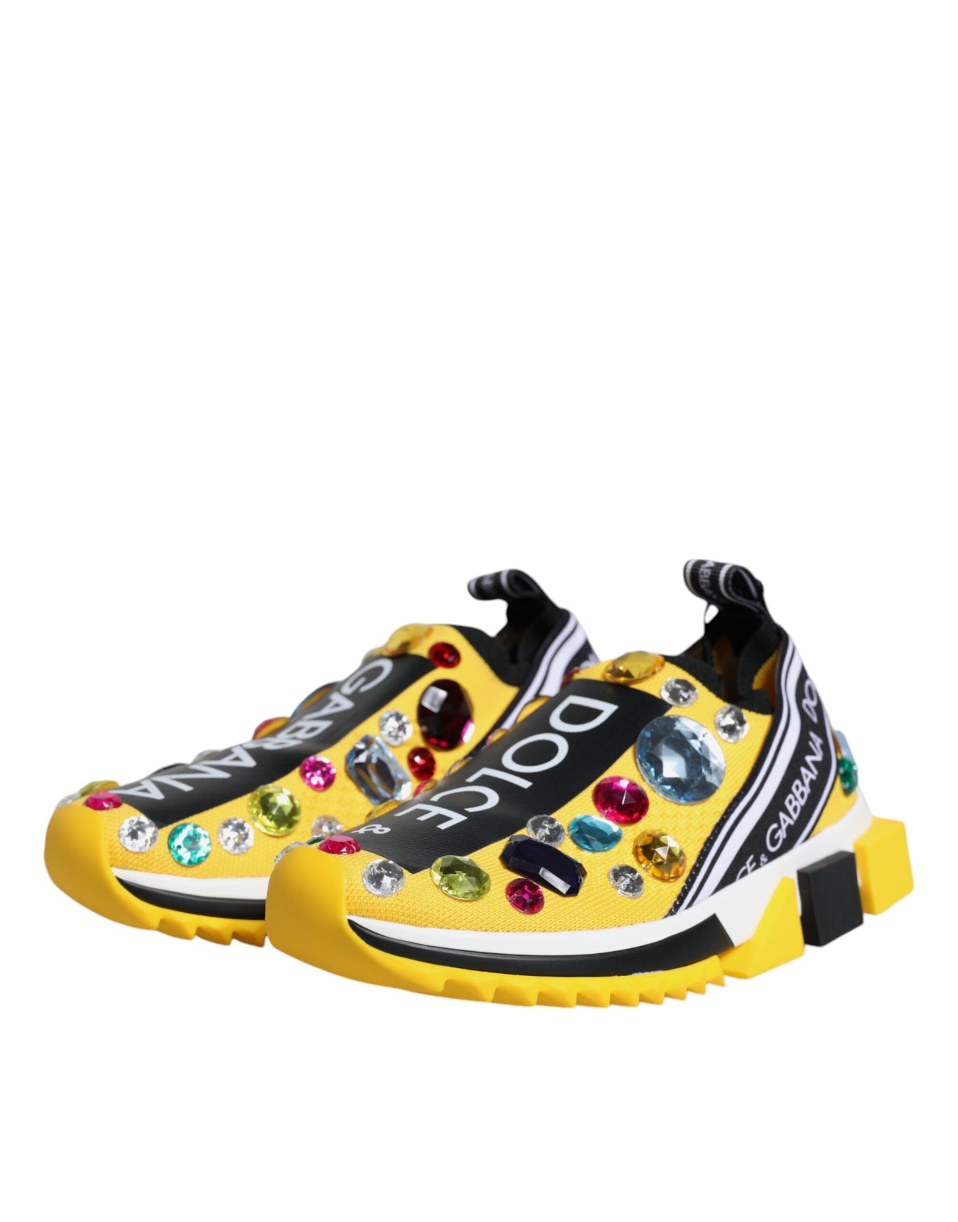 A pair of yellow sneakers with crystal embellishments and a black logo