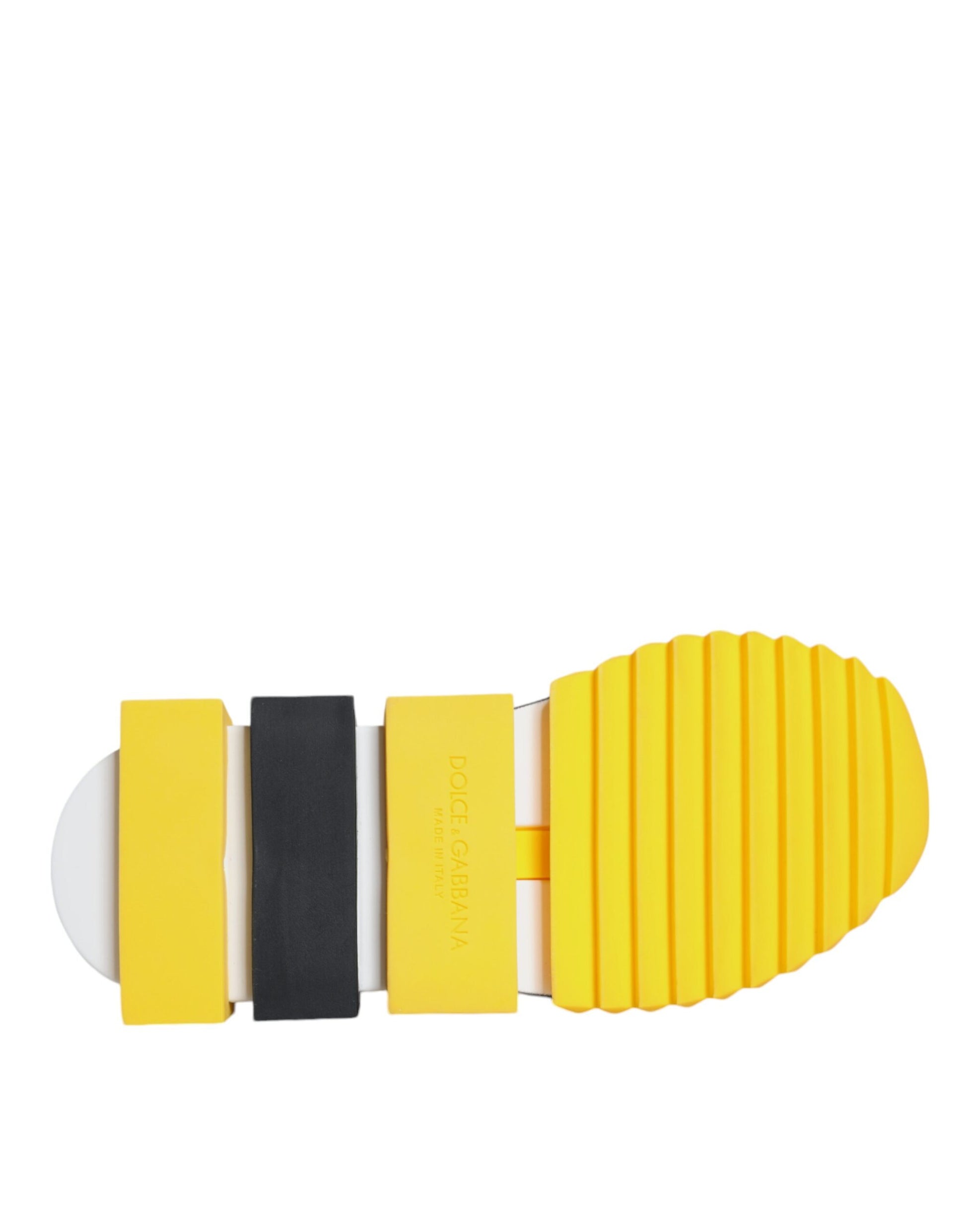 A pair of yellow and black sneakers with crystal embellishments