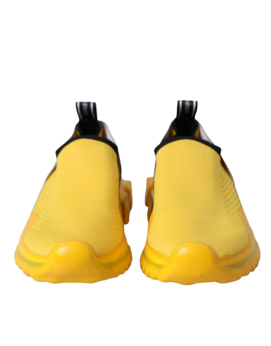 Pair of yellow sneakers with black laces and soles