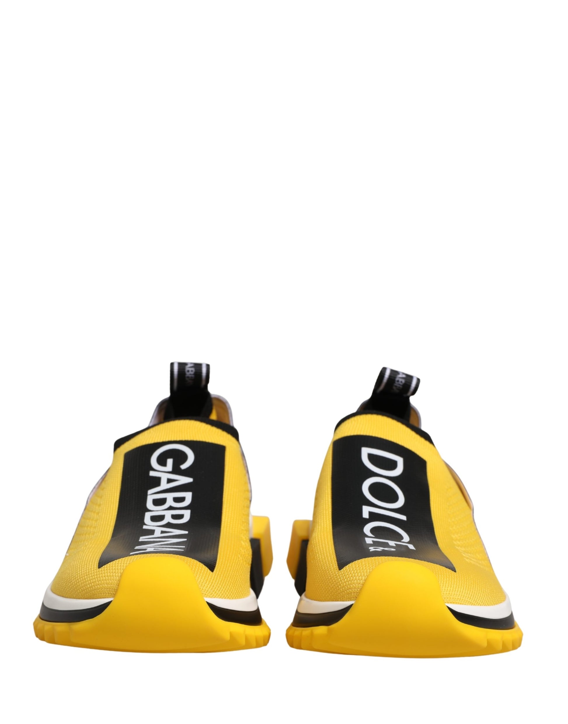 Pair of yellow slip-on shoes with black and white text on the side