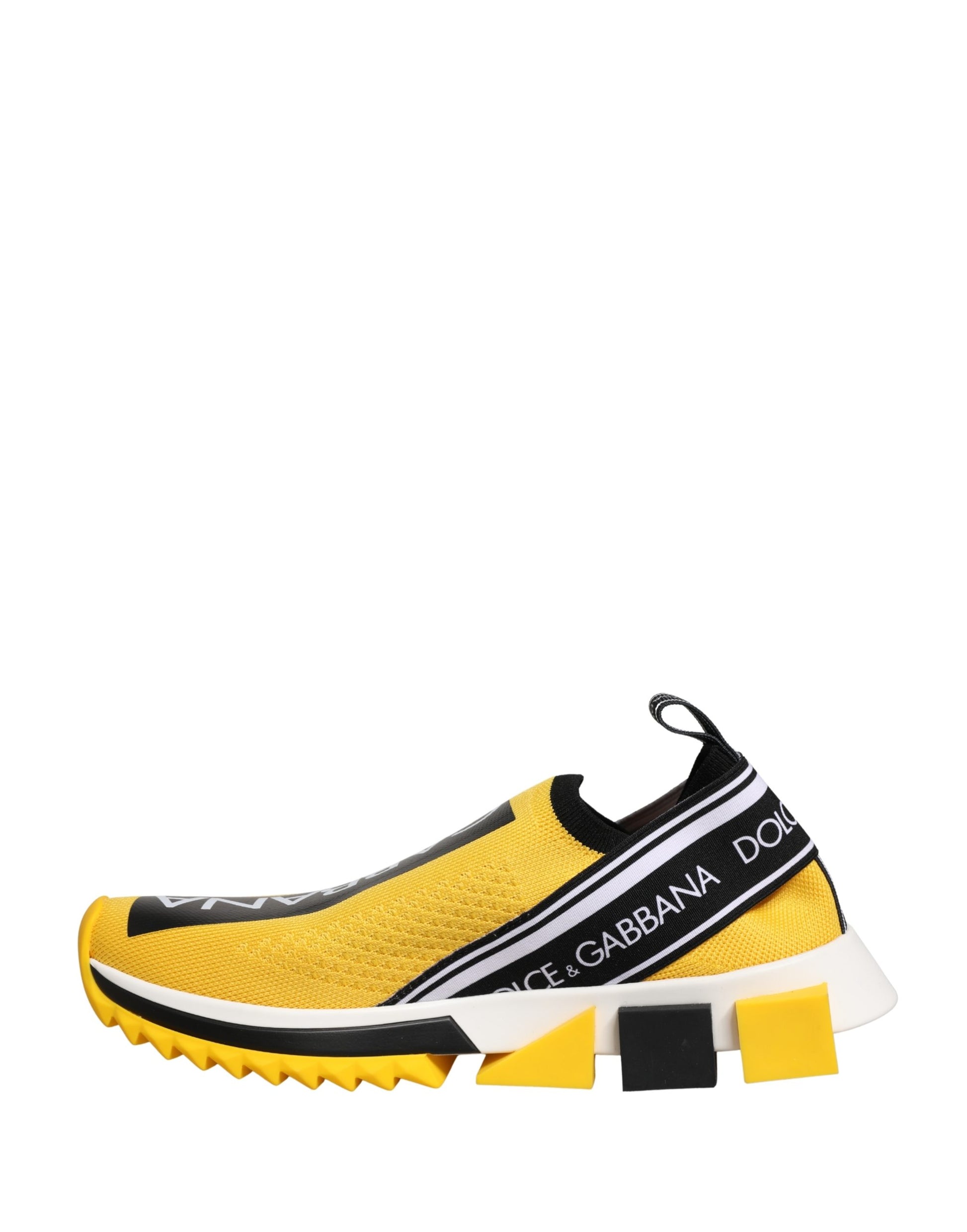 A pair of yellow slip-on shoes with black and white stripes on the side