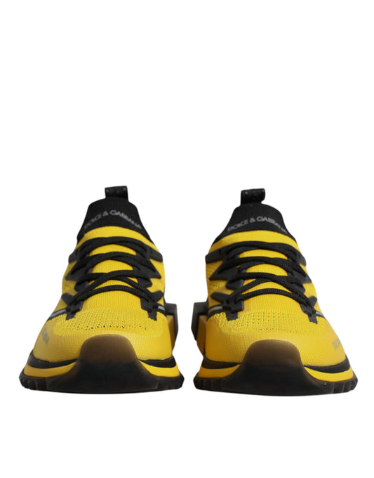 Pair of yellow and black athletic shoes with laces