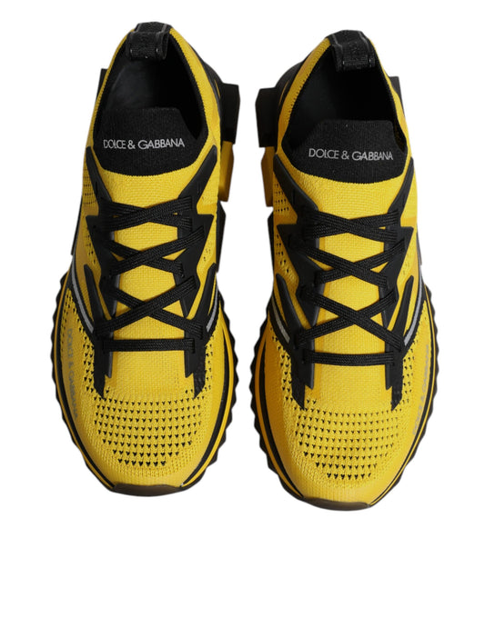 Pair of yellow and black athletic shoes with laces